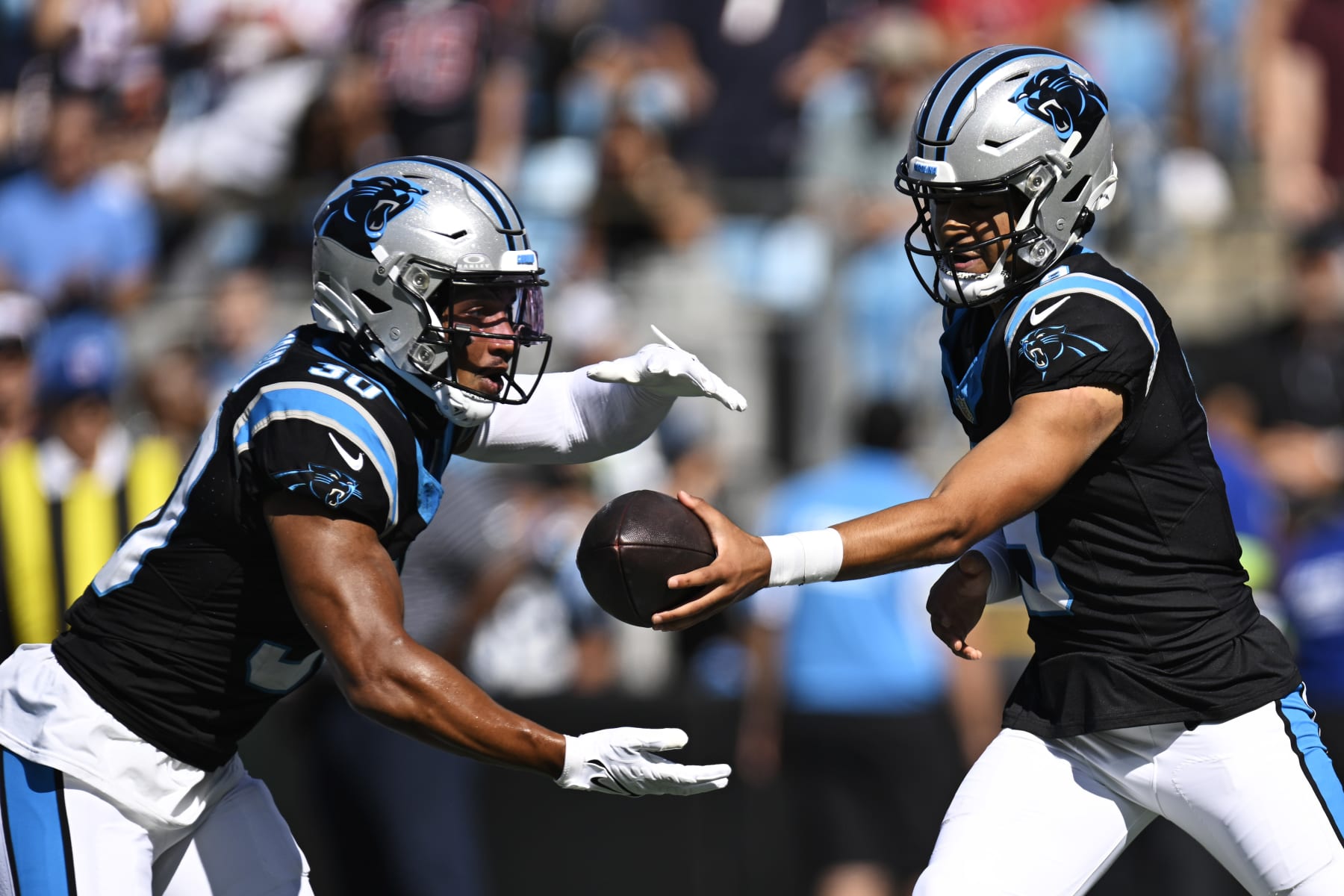 CHARLOTTE, NORTH CAROLINA - OCTOBER 29: Bryce Young #9 hands the ball to Chuba Hubbard #30 of the Carolina Panthers in the second quarter at Bank of America Stadium on October 29, 2023 in Charlotte, North Carolina. (Photo by Eakin Howard/Getty Images)