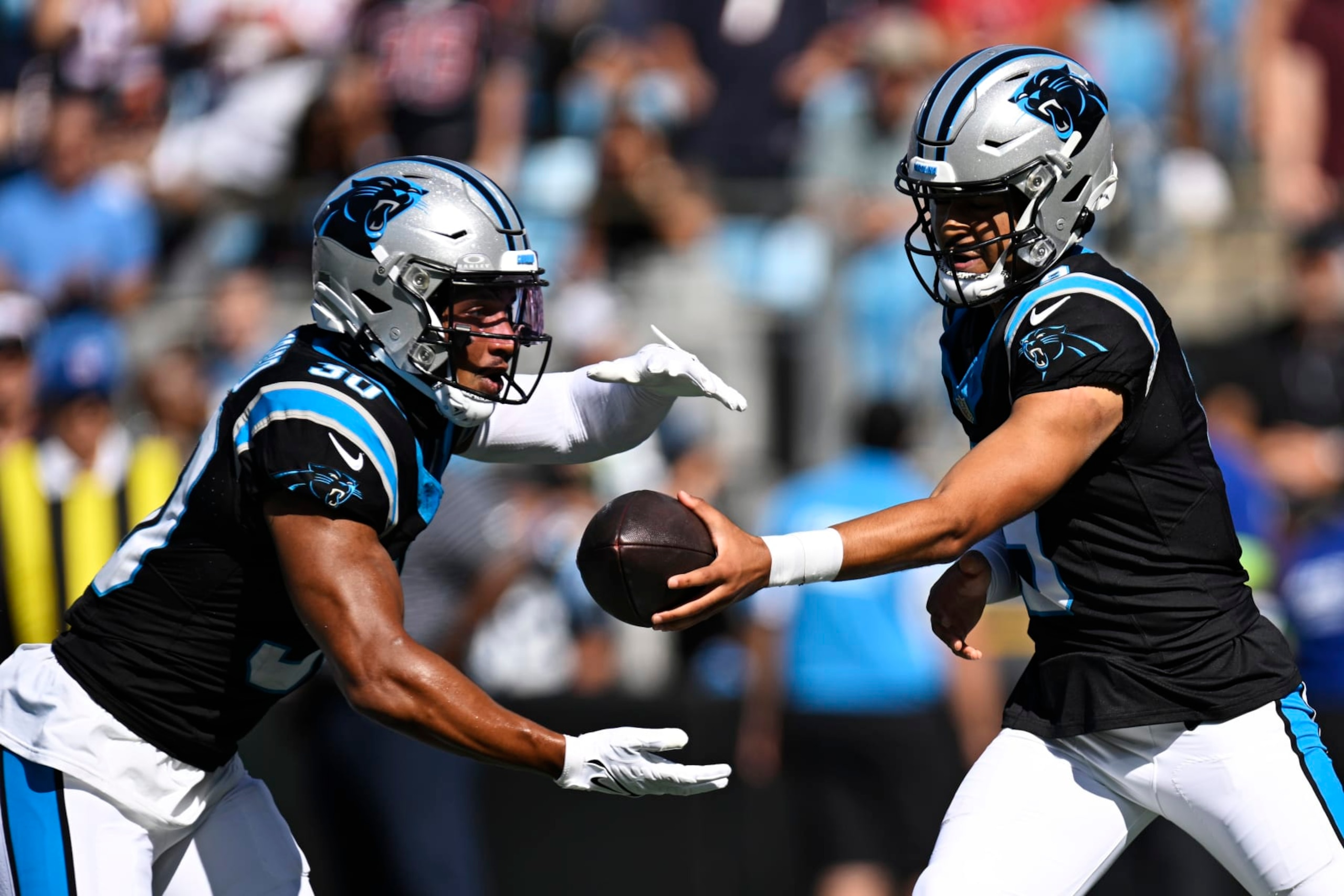 CHARLOTTE, NORTH CAROLINA - OCTOBER 29: Bryce Young #9 hands the ball to Chuba Hubbard #30 of the Carolina Panthers in the second quarter at Bank of America Stadium on October 29, 2023 in Charlotte, North Carolina. (Photo by Eakin Howard/Getty Images)