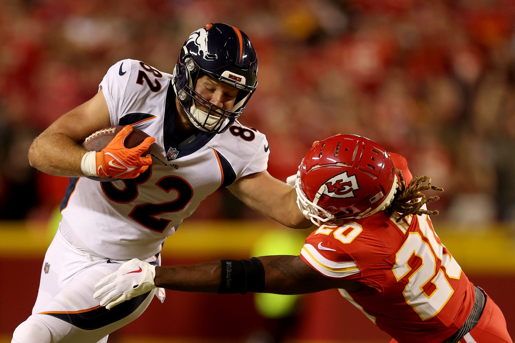 KANSAS CITY, MISSOURI - OCTOBER 12: Adam Trautman #82 of the Denver Broncos stiff arms Justin Reid #20 of the Kansas City Chiefs during the first quarter at GEHA Field at Arrowhead Stadium on October 12, 2023 in Kansas City, Missouri. (Photo by Jamie Squire/Getty Images)