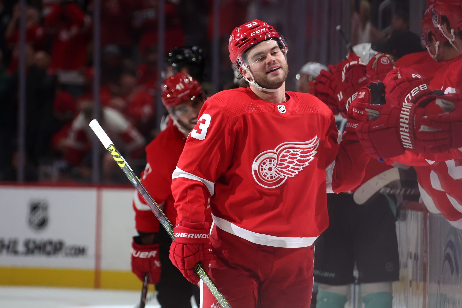DETROIT, MICHIGAN - OCTOBER 24: Alex DeBrincat #93 of the Detroit Red Wings celebrates his third period goal with teammates while playing the Seattle Kraken at Little Caesars Arena on October 24, 2023 in Detroit, Michigan. (Photo by Gregory Shamus/Getty Images)