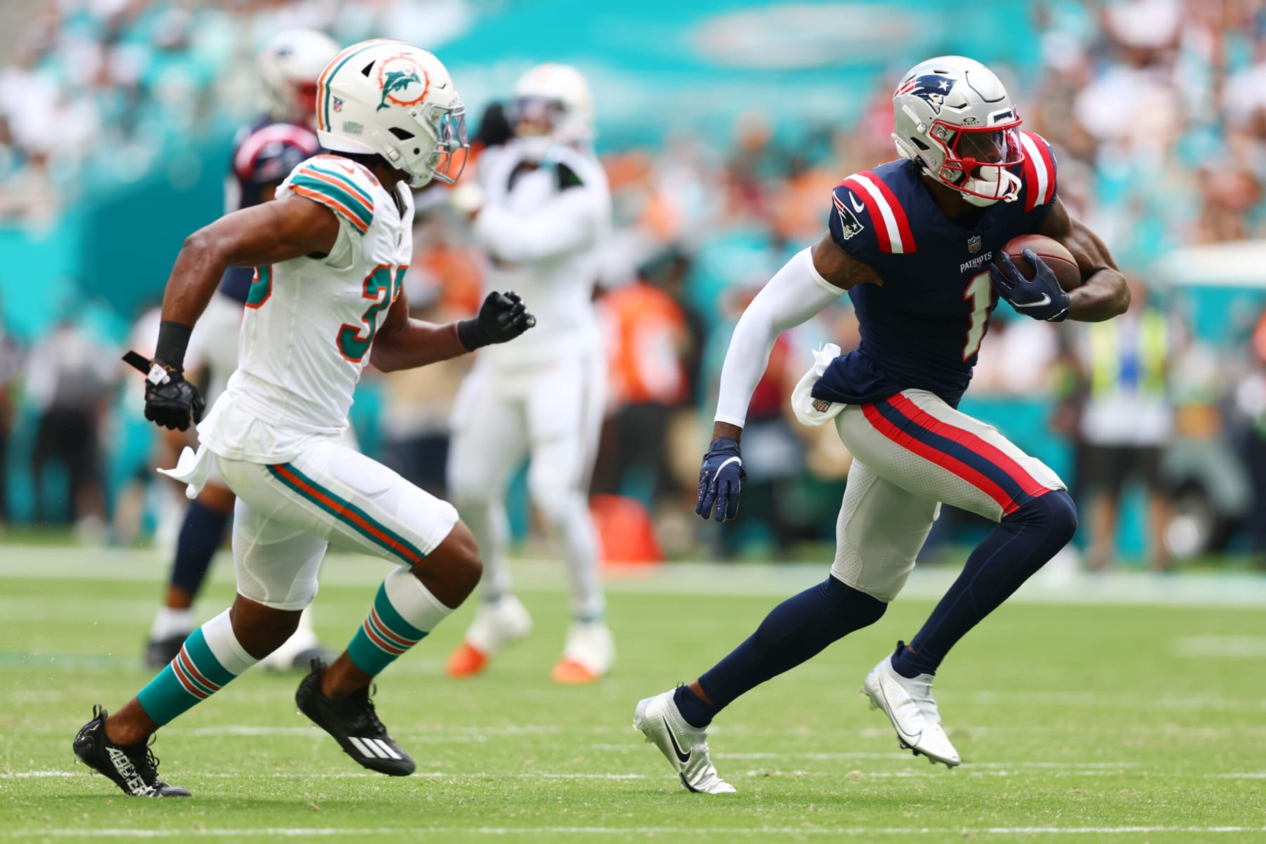 MIAMI GARDENS, FLORIDA - OCTOBER 29: DeVante Parker #1 of the New England Patriots runs past Eli Apple #33 of the Miami Dolphins during the second quarter at Hard Rock Stadium on October 29, 2023 in Miami Gardens, Florida. (Photo by Megan Briggs/Getty Images)
