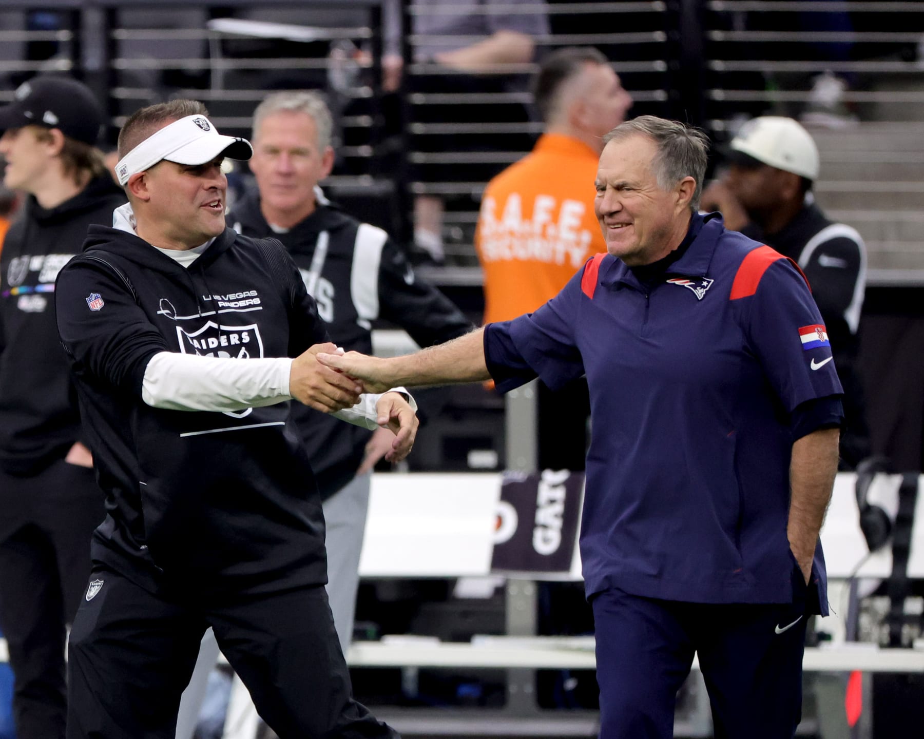 LAS VEGAS, NEVADA - chick of the New England Patriots 
 DECEMBER 18: Head coach Bill Belichick of the New England Patriots and head coach Josh McDaniels of the Las Vegas Raiders talk before a game at Allegiant Stadium on December 18, 2022 in Las Vegas, Nevada. (Photo by Ethan Miller/Getty Images)