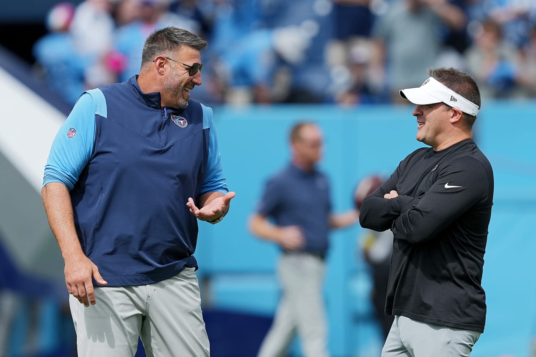 NASHVILLE, TENNESSEE - SEPTEMBER 25: Head coaches Mike Vrabel (L) of the Tennessee Titans and Josh McDaniels of the Las Vegas Raiders interact before the game at Nissan Stadium on September 25, 2022 in Nashville, Tennessee. (Photo by Dylan Buell/Getty Images)
