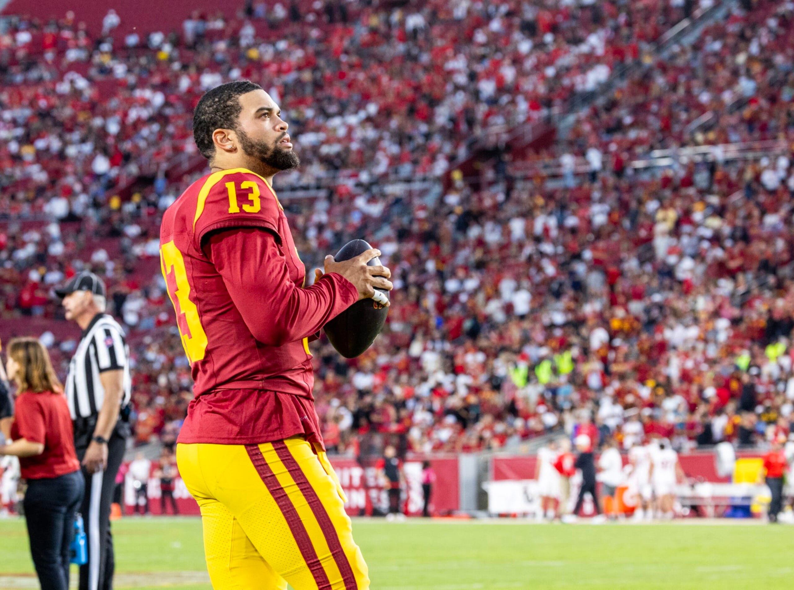 LOS ANGELES, CA  - OCTOBER 21, 2023: USC Trojans  quarterback Caleb Williams looks up at the score board while staying loose during a timeout in the 34-32 loss to Utah at LA Memorial Coliseum on October 21,  2023 in Los Angeles, California.(Gina Ferazzi / Los Angeles Times via Getty Images)