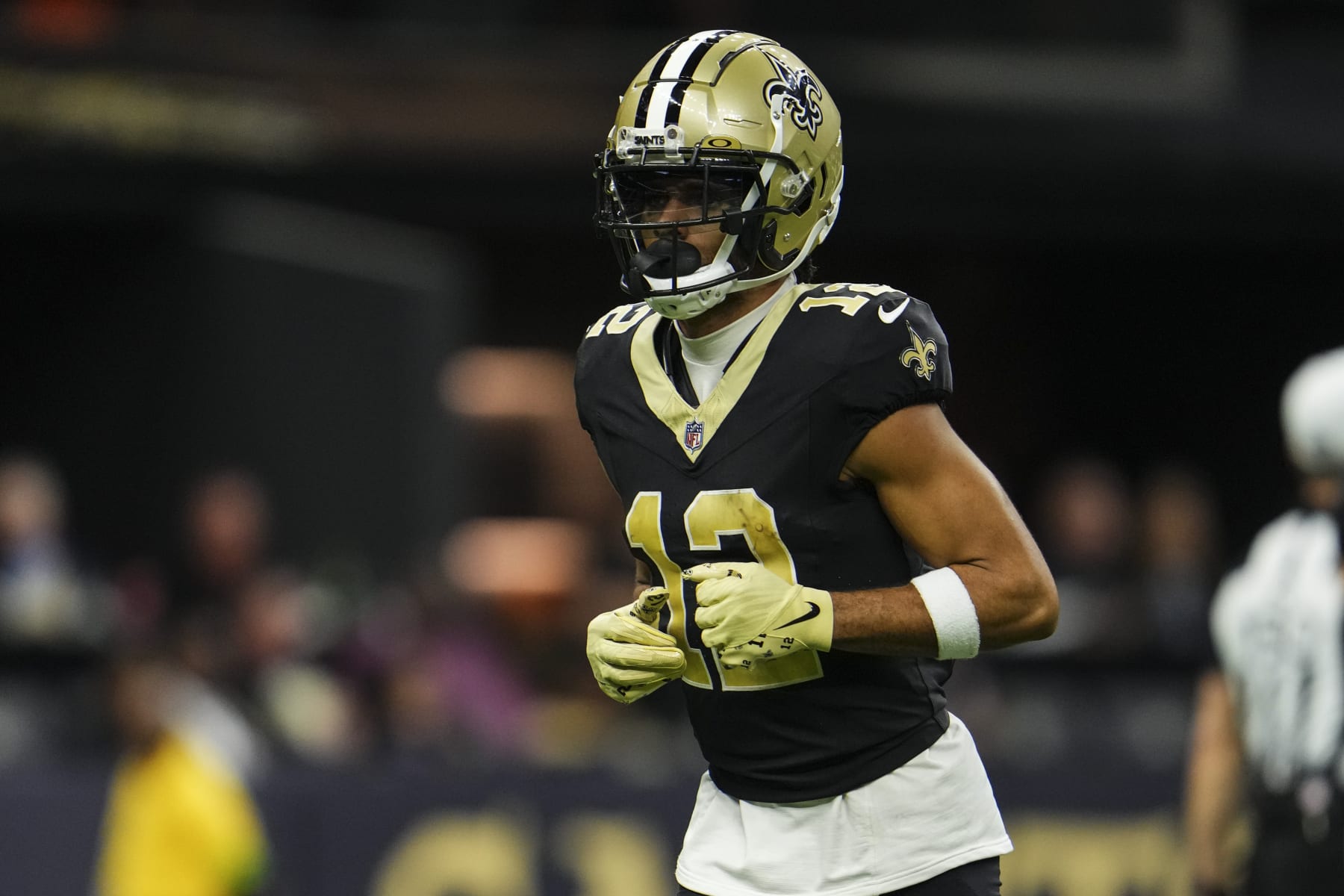 NEW ORLEANS, LA - OCTOBER 19: Chris Olave #12 of the New Orleans Saints runs across the field during an NFL football game against the Jacksonville Jaguars at Caesars Superdome on October 19, 2023 in New Orleans, Louisiana. (Photo by Cooper Neill/Getty Images)