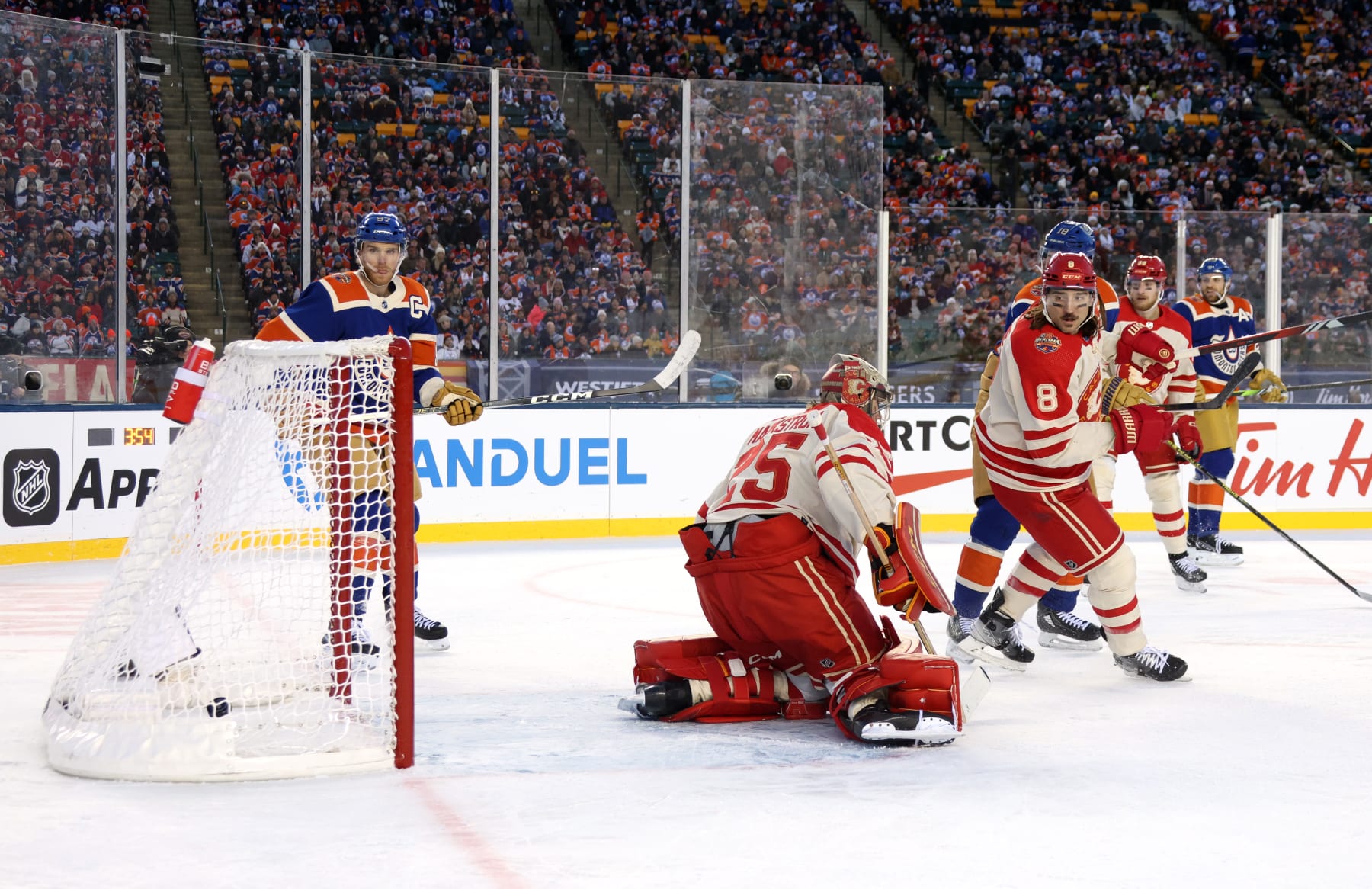 EDMONTON, ALBERTA - OCTOBER 29: Goaltender Jacob Markstrom #25 of the Calgary Flames can't make the save on a shot from the point for a goal by Evan Bouchard #2 of the Edmonton Oilers (not in photo) as Connor McDavid #97 of the Edmonton Oilers and Chris Tanev #8 of the Calgary Flames look on during the first period of the 2023 Tim Hortons NHL Heritage Classic between the Calgary Flames and the Edmonton Oilers at Commonwealth Stadium on October 29, 2023 in Edmonton, Alberta. (Photo by Dave Sandford/NHLI via Getty Images)