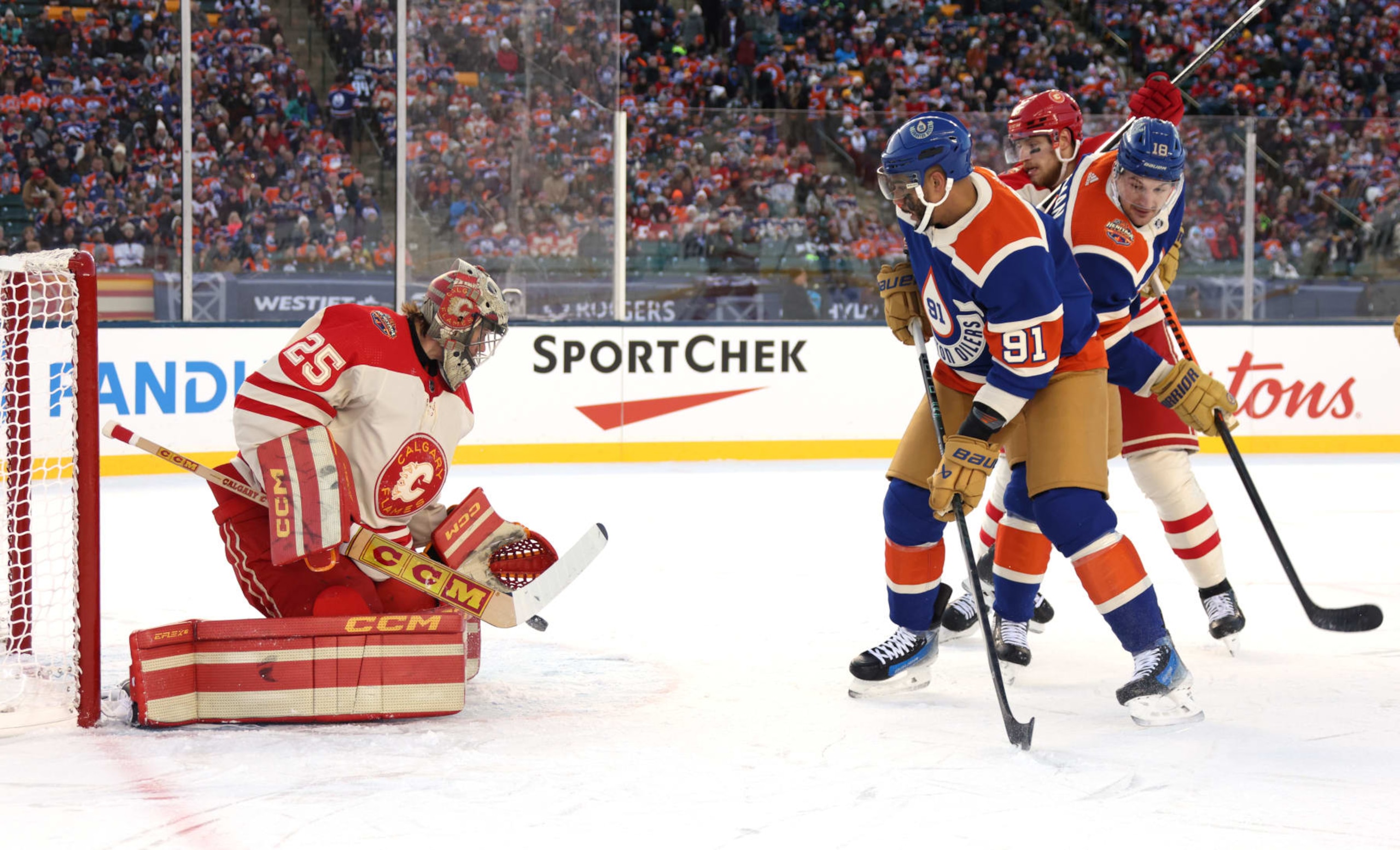 EDMONTON, ALBERTA - OCTOBER 29: Evander Kane #91 of the Edmonton Oilers looks for the rebound as goaltender Jacob Markstrom #25 of the Calgary Flames makes a save in the first period of the 2023 Tim Hortons NHL Heritage Classic between the Calgary Flames and the Edmonton Oilers at Commonwealth Stadium on October 29, 2023 in Edmonton, Alberta. (Photo by Dave Sandford/NHLI via Getty Images) EDMONTON, ALBERTA - OCTOBER 29: Evander Kane #91 of the Edmonton Oilers looks for the rebound as goaltender Jacob Markstrom #25 of the Calgary Flames makes a save in the first period of the 2023 Tim Hortons NHL Heritage Classic between the Calgary Flames and the Edmonton Oilers at Commonwealth Stadium on October 29, 2023 in Edmonton, Alberta. (Photo by Dave Sandford/NHLI via Getty Images)