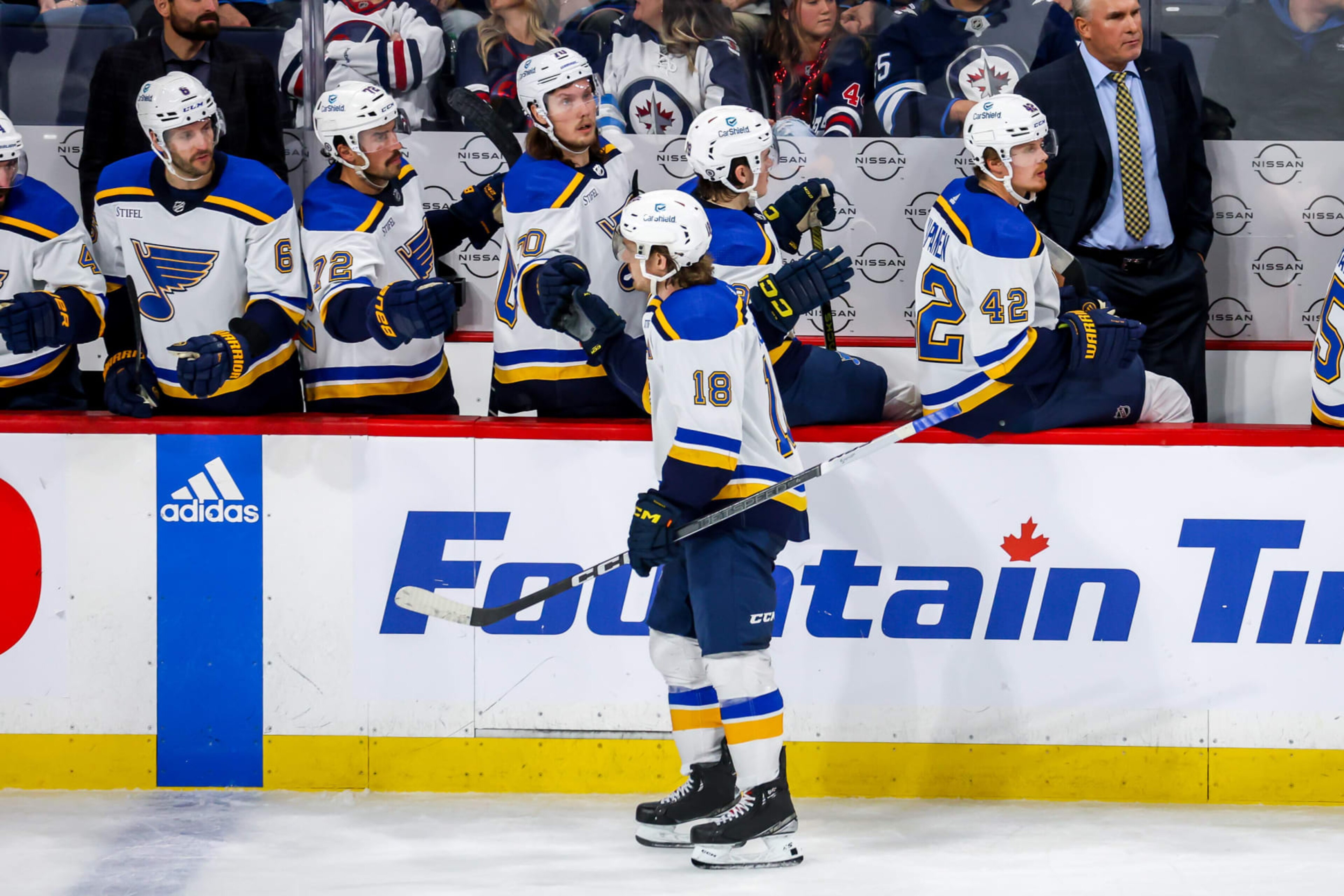 WINNIPEG, CANADA - OCTOBER 24: Robert Thomas #18 of the St. Louis Blues celebrates his third period goal against the Winnipeg Jets with teammates at the bench at the Canada Life Centre on October 24, 2023 in Winnipeg, Manitoba, Canada. (Photo by Jonathan Kozub/NHLI via Getty Images)