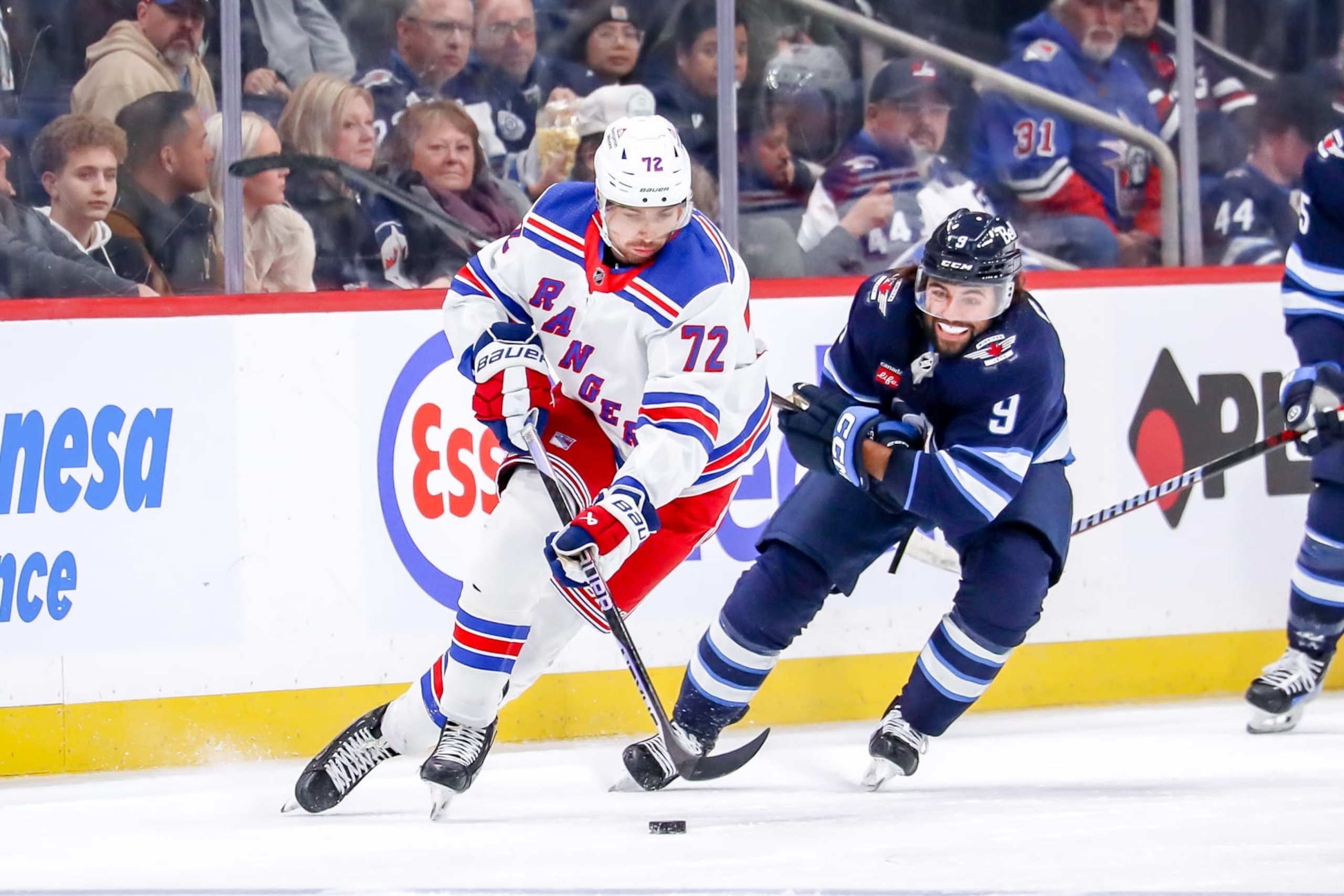 WINNIPEG, CANADA - OCTOBER 30: Filip Chytil #72 of the New York Rangers plays the puck down the ice as Alex Iafallo #9 of the Winnipeg Jets gives chase during second period action at the Canada Life Centre on October 30, 2023 in Winnipeg, Manitoba, Canada. (Photo by Darcy Finley/NHLI via Getty Images) WINNIPEG, CANADA - OCTOBER 30: Filip Chytil #72 of the New York Rangers plays the puck down the ice as Alex Iafallo #9 of the Winnipeg Jets gives chase during second period action at the Canada Life Centre on October 30, 2023 in Winnipeg, Manitoba, Canada. (Photo by Darcy Finley/NHLI via Getty Images)
