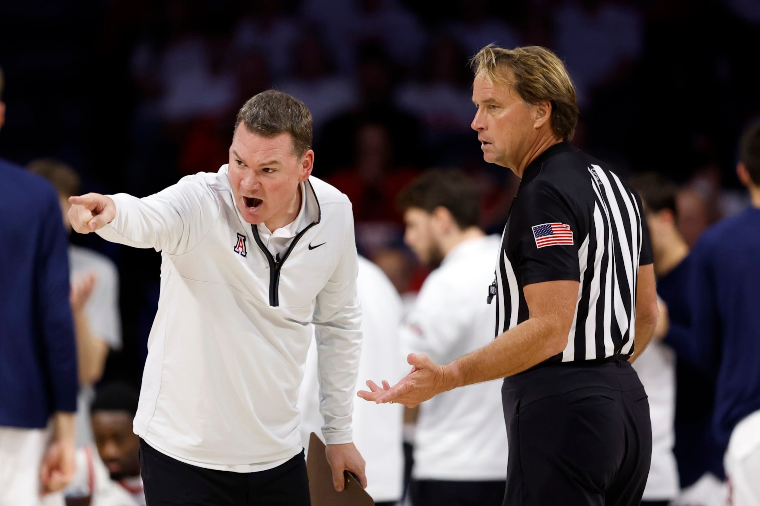 Arizona's Tommy Lloyd and referee John Higgins