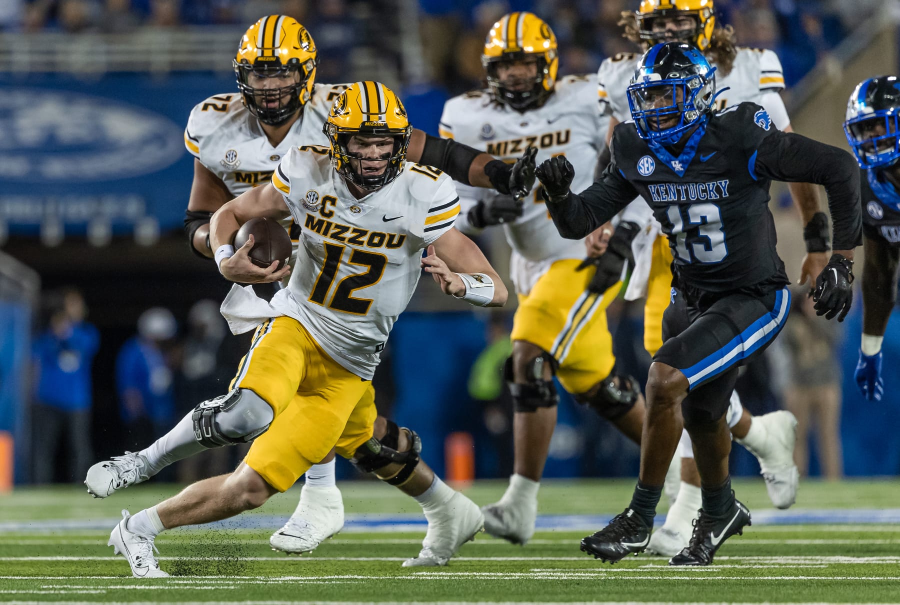 LEXINGTON, KENTUCKY - OCTOBER 14: Brady Cook #12 of the Missouri Tigers runs the ball during the game against the Kentucky Wildcats at Kroger Field on October 14, 2023 in Lexington, Kentucky. (Photo by Michael Hickey/Getty Images)