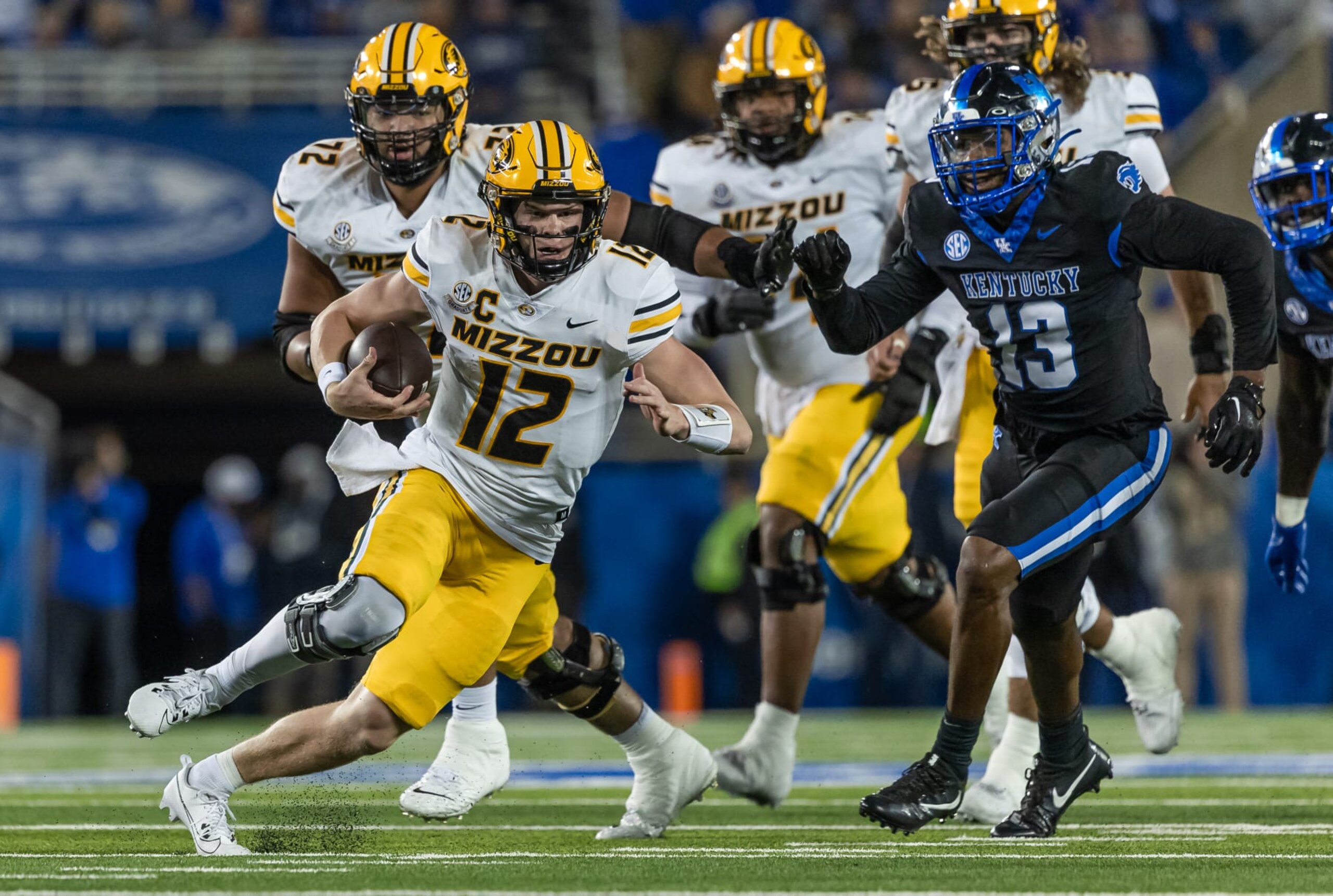 LEXINGTON, KENTUCKY - OCTOBER 14: Brady Cook #12 of the Missouri Tigers runs the ball during the game against the Kentucky Wildcats at Kroger Field on October 14, 2023 in Lexington, Kentucky. (Photo by Michael Hickey/Getty Images)