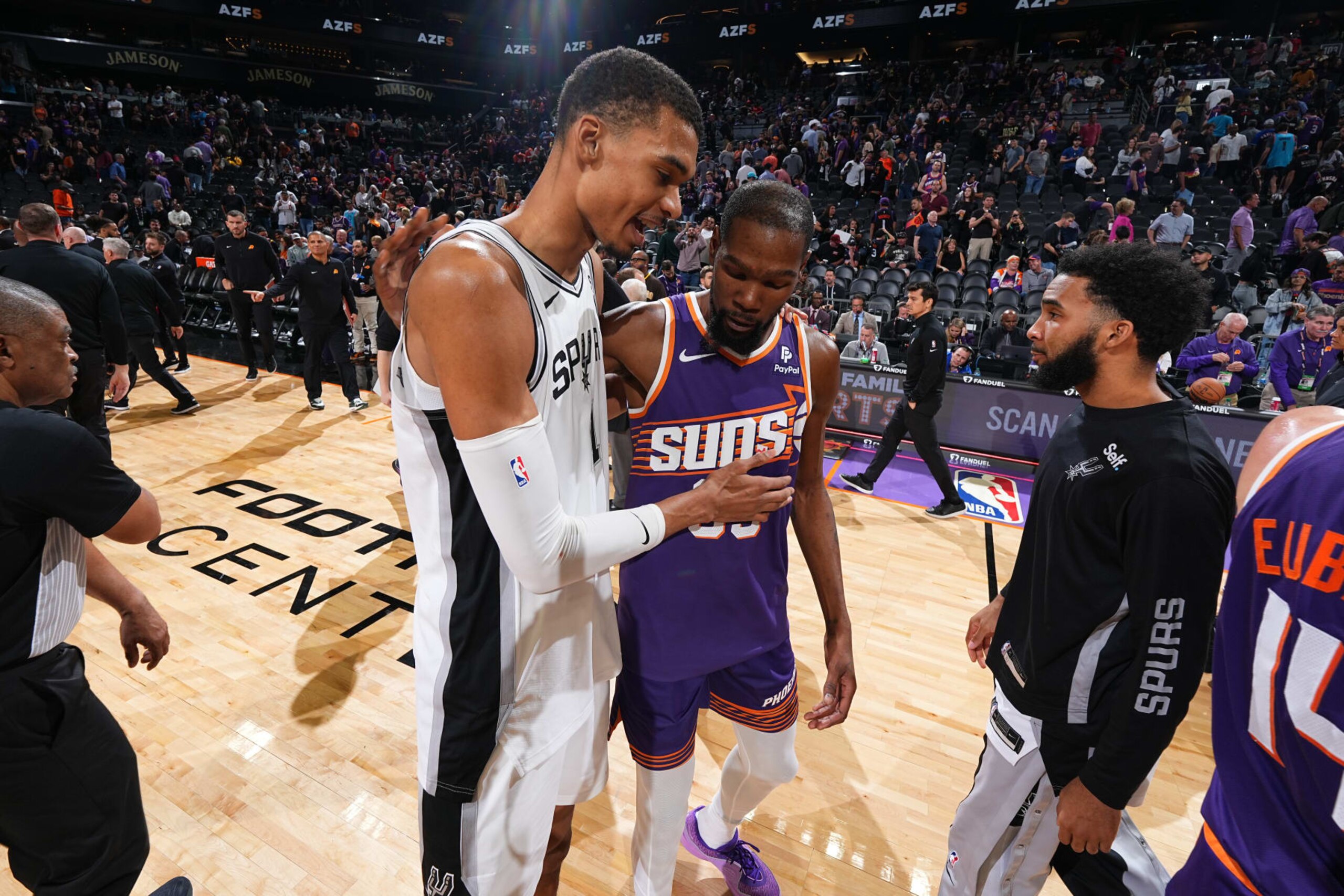 PHOENIX, AZ - NOVEMBER 2: Victor Wembanyama #1 of the San Antonio Spurs and Kevin Durant #35 of the Phoenix Suns talk after the game on November 2, 2023 at Footprint Center in Phoenix, Arizona. NOTE TO USER: User expressly acknowledges and agrees that, by downloading and or using this photograph, user is consenting to the terms and conditions of the Getty Images License Agreement. Mandatory Copyright Notice: Copyright 2023 NBAE (Photo by Garrett Ellwood/NBAE via Getty Images) PHOENIX, AZ - NOVEMBER 2: Victor Wembanyama #1 of the San Antonio Spurs and Kevin Durant #35 of the Phoenix Suns talk after the game on November 2, 2023 at Footprint Center in Phoenix, Arizona. NOTE TO USER: User expressly acknowledges and agrees that, by downloading and or using this photograph, user is consenting to the terms and conditions of the Getty Images License Agreement. Mandatory Copyright Notice: Copyright 2023 NBAE (Photo by Garrett Ellwood/NBAE via Getty Images)