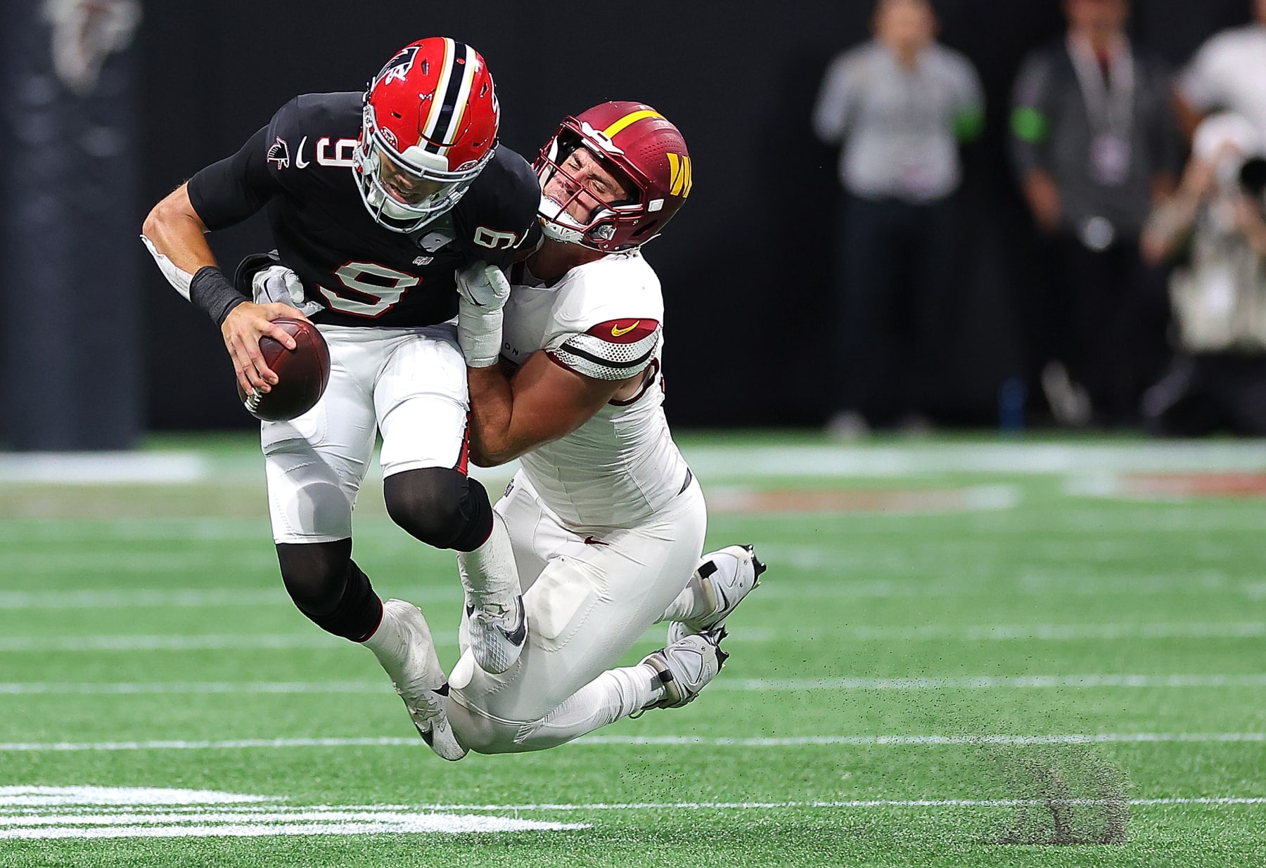 ATLANTA, GEORGIA - OCTOBER 15:  Desmond Ridder #9 of the Atlanta Falcons is sacked by Casey Toohill #95 of the Washington Commanders during the third quarter at Mercedes-Benz Stadium on October 15, 2023 in Atlanta, Georgia. (Photo by Kevin C. Cox/Getty Images)