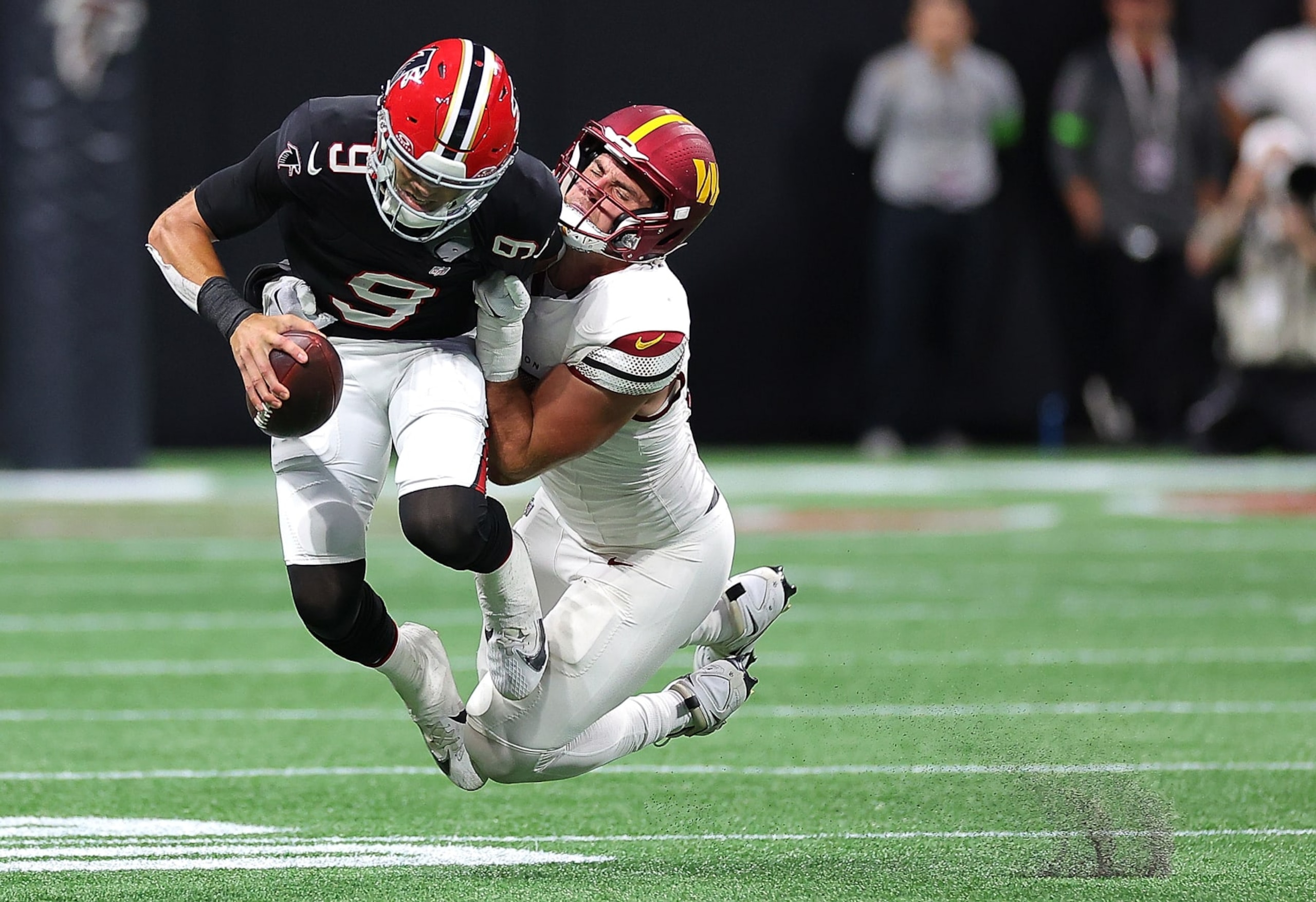 ATLANTA, GEORGIA - OCTOBER 15:  Desmond Ridder #9 of the Atlanta Falcons is sacked by Casey Toohill #95 of the Washington Commanders during the third quarter at Mercedes-Benz Stadium on October 15, 2023 in Atlanta, Georgia. (Photo by Kevin C. Cox/Getty Images)