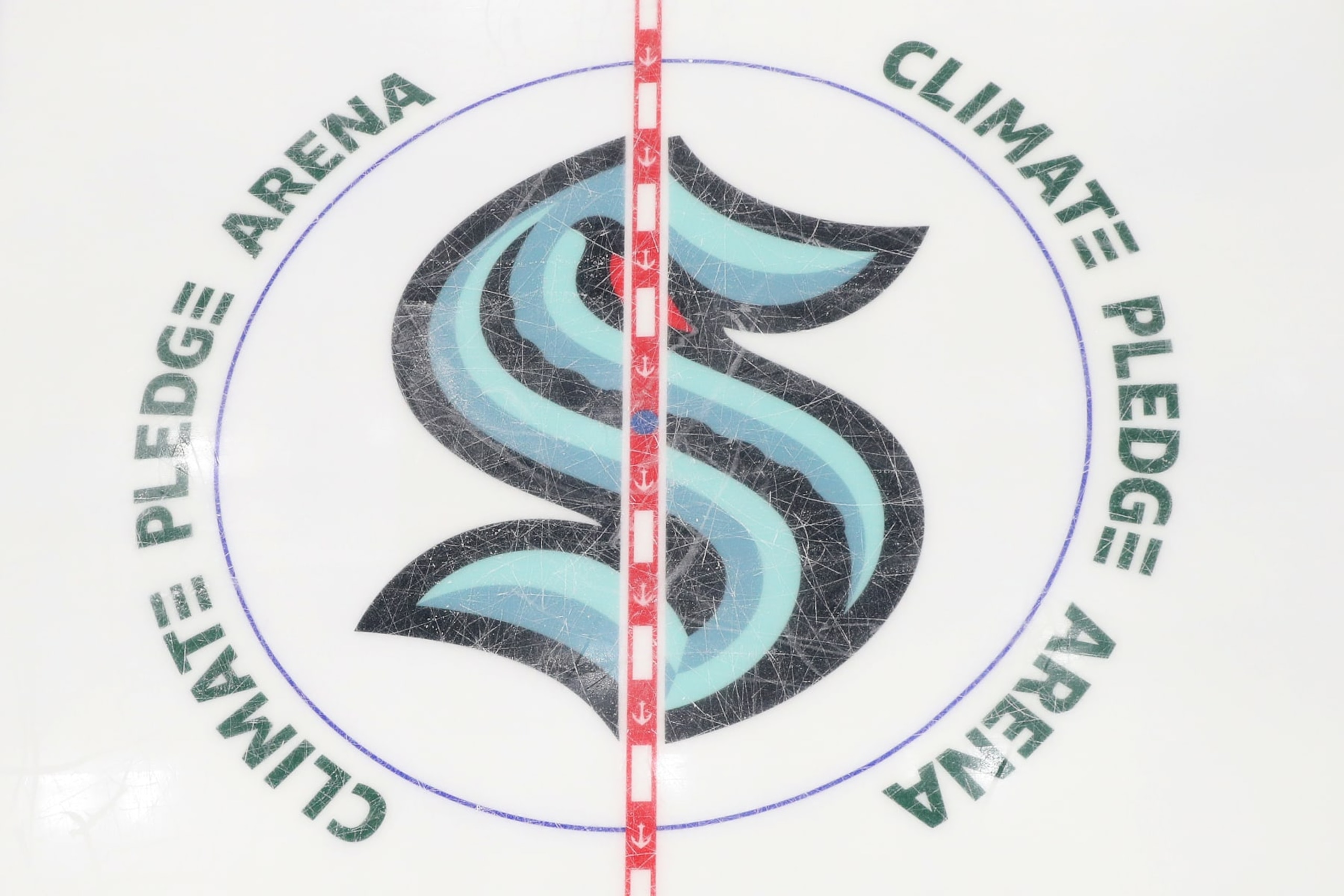 SEATTLE, WASHINGTON - OCTOBER 23: A general view of the Seattle Kraken center ice logo is seen during the first period against the Vancouver Canucks in the Kraken's inaugural home opener on October 23, 2021 at Climate Pledge Arena in Seattle, Washington. (Photo by Steph Chambers/Getty Images) SEATTLE, WASHINGTON - OCTOBER 23: A general view of the Seattle Kraken center ice logo is seen during the first period against the Vancouver Canucks in the Kraken's inaugural home opener on October 23, 2021 at Climate Pledge Arena in Seattle, Washington. (Photo by Steph Chambers/Getty Images)