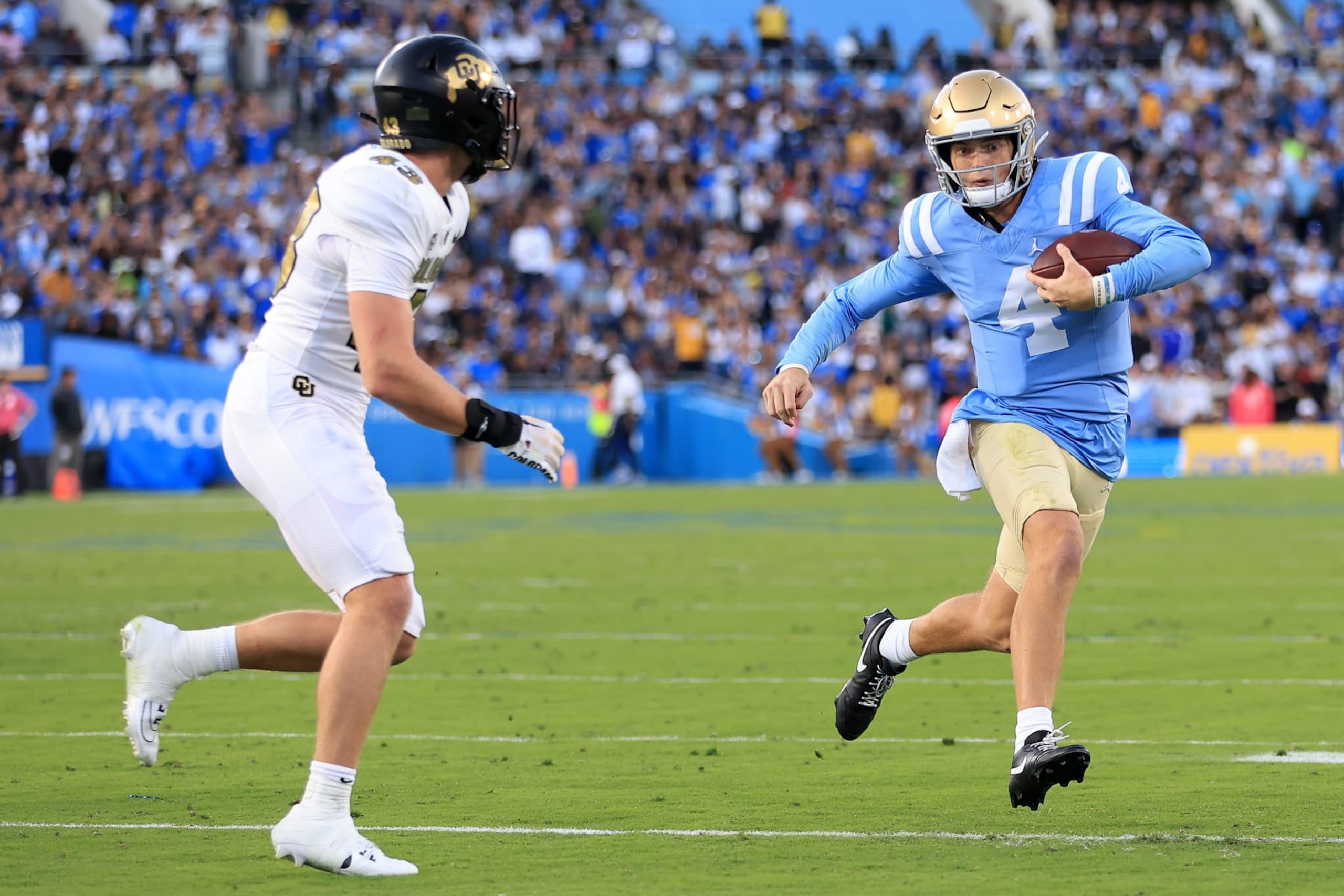 PASADENA, CALIFORNIA - OCTOBER 28: Trevor Woods #43 of the Colorado Buffaloes chases Ethan Garbers #4 of the UCLA Bruins during the first half of a game at Rose Bowl Stadium on October 28, 2023 in Pasadena, California. (Photo by Sean M. Haffey/Getty Images)