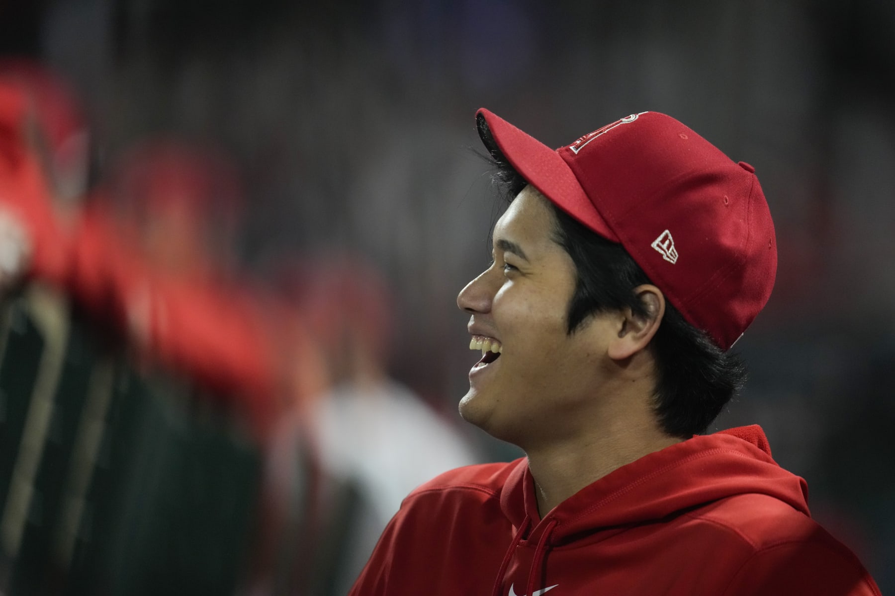 Los Angeles Angels' Shohei Ohtani laughs in the dugout during the ninth inning of a baseball game against the Detroit Tigers in Anaheim, Calif., Saturday, Sept. 16, 2023. (AP Photo/Ashley Landis)