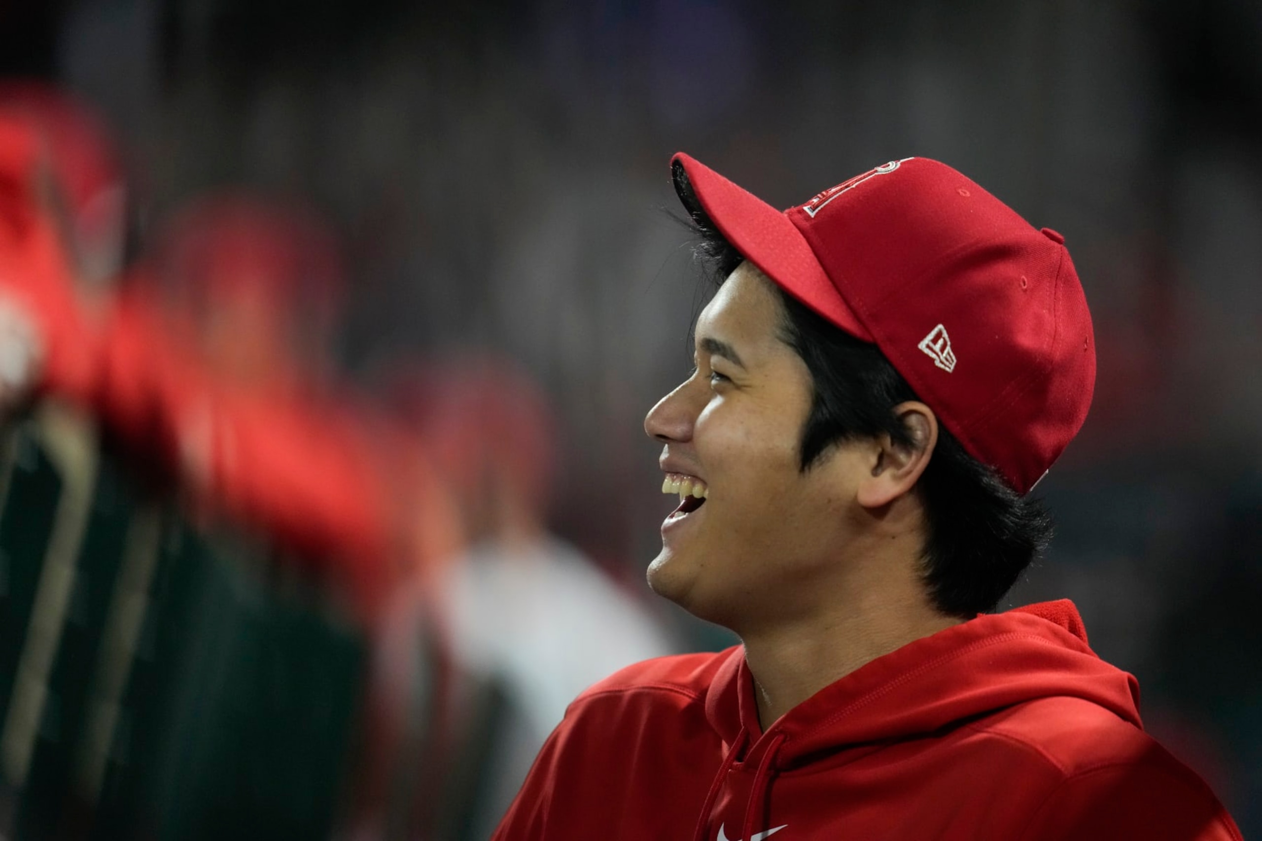 Los Angeles Angels' Shohei Ohtani laughs in the dugout during the ninth inning of a baseball game against the Detroit Tigers in Anaheim, Calif., Saturday, Sept. 16, 2023. (AP Photo/Ashley Landis)