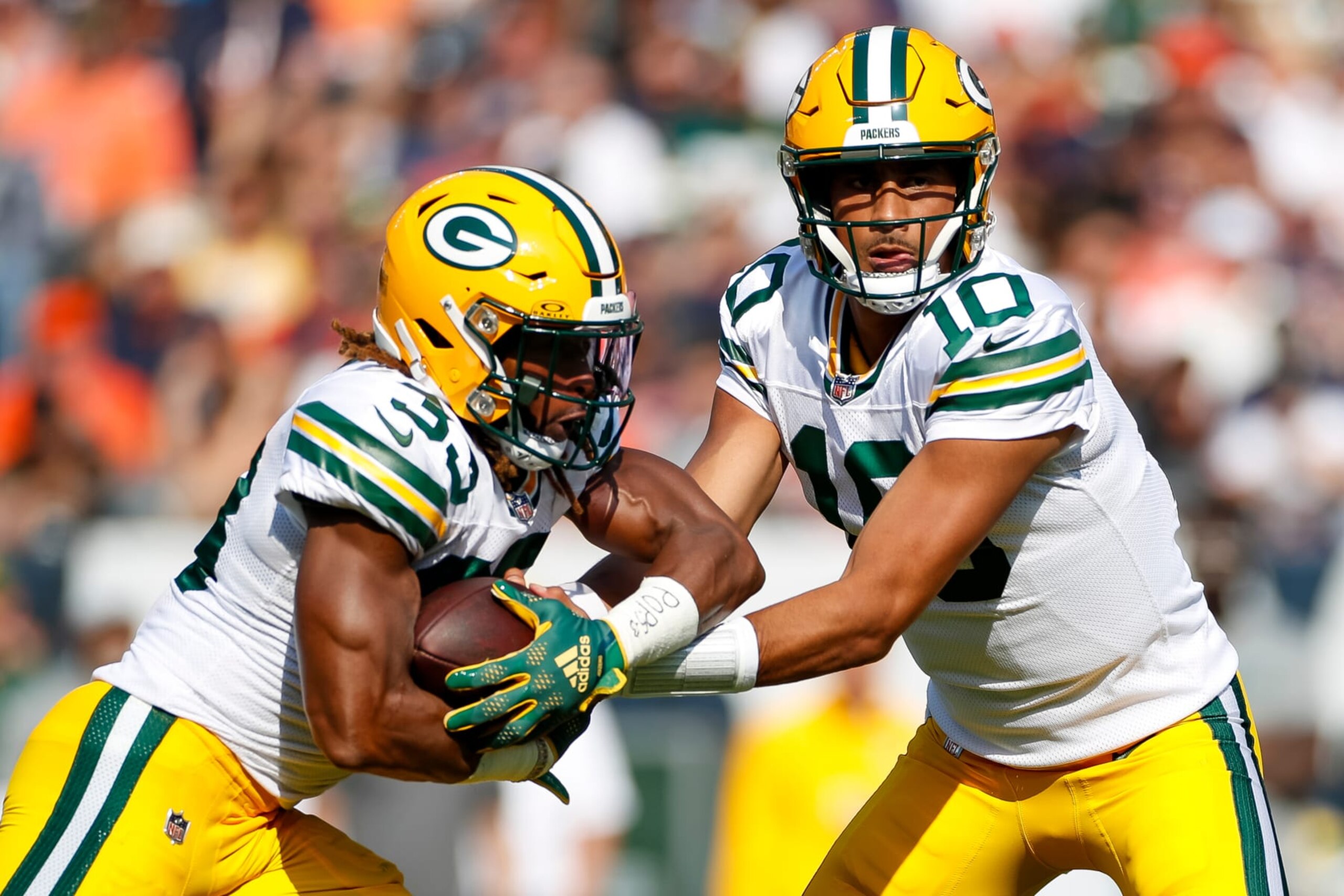 CHICAGO, IL - SEPTEMBER 10: Green Bay Packers quarterback Jordan Love (10) hands the ball off to running back Aaron Jones (33) in the first quarter during a regular season game between the Green Bay Packers and the Chicago Bears on September, 10, 2023, at Soldier Field in Chicago, IL. (Photo by Brandon Sloter/Icon Sportswire via Getty Images)