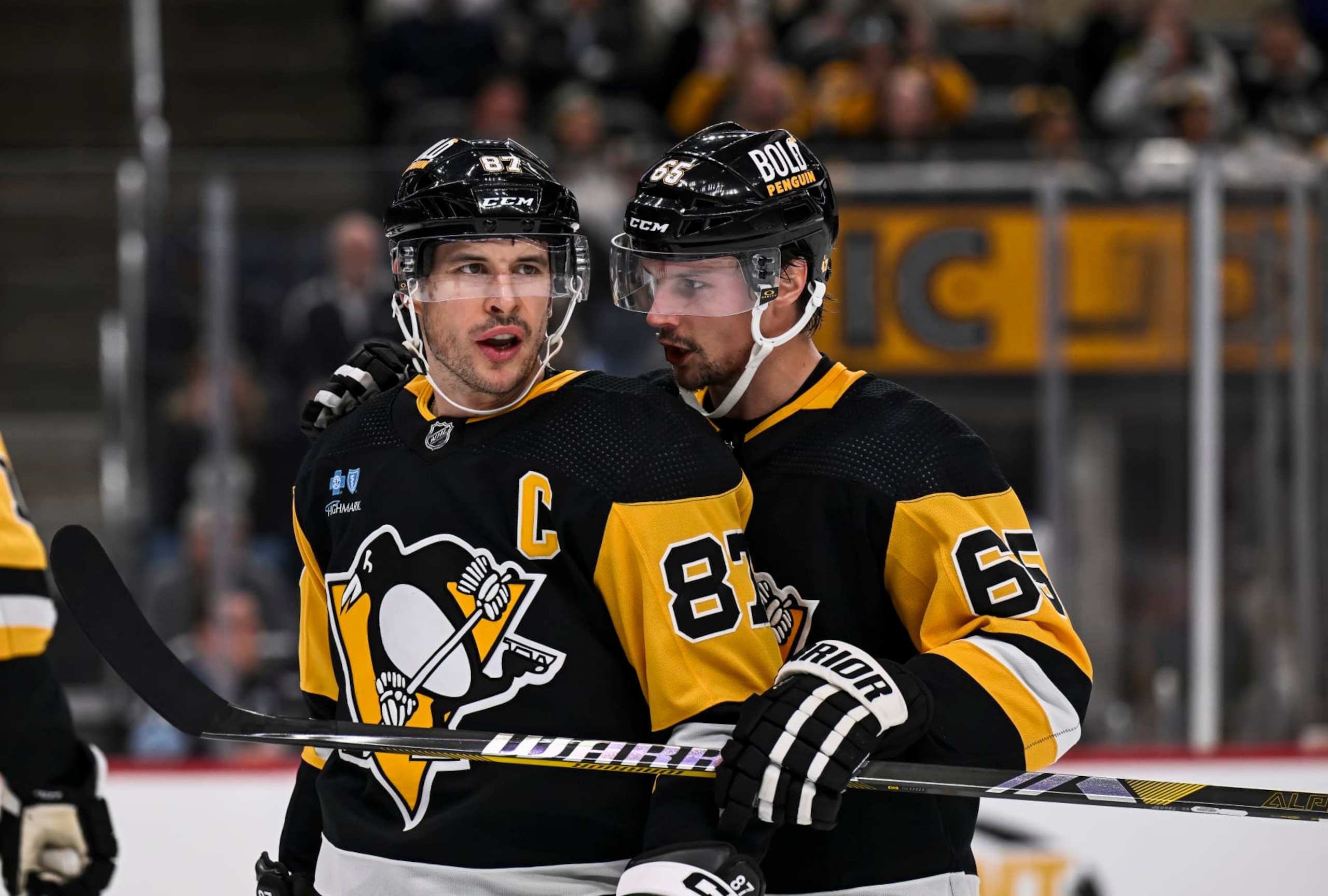 PITTSBURGH, PA - OCTOBER 30:Pittsburgh Penguins defenseman Erik Karlsson (65) talks to Pittsburgh Penguins center Sidney Crosby (87) during a break in the second period in the NHL game between the Pittsburgh Penguins and the Anaheim Ducks on October 30, 2023, at PPG Paints Arena in Pittsburgh, PA. (Photo by Jeanine Leech/Icon Sportswire via Getty Images)