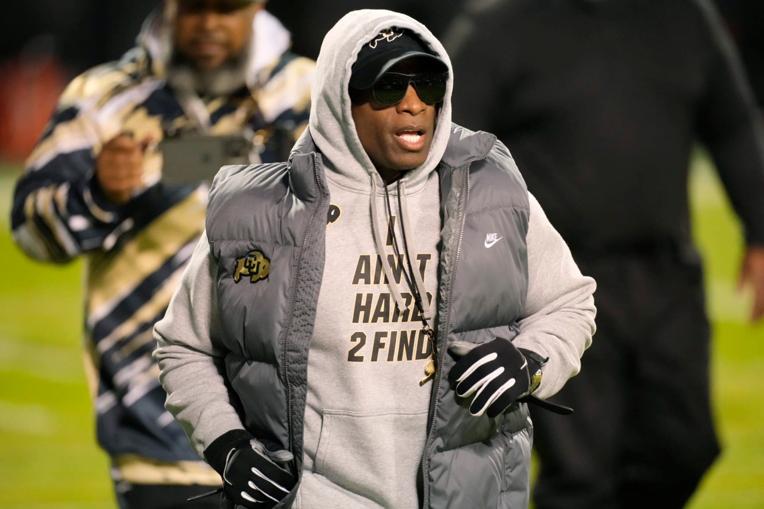 Colorado head coach Deion Sanders walks the perimeter of the field as players warm up for an NCAA college football game against Oregon State on Saturday, Nov. 4, 2023, in Boulder, Colo. (AP Photo/David Zalubowski) Colorado head coach Deion Sanders walks the perimeter of the field as players warm up for an NCAA college football game against Oregon State on Saturday, Nov. 4, 2023, in Boulder, Colo. (AP Photo/David Zalubowski)