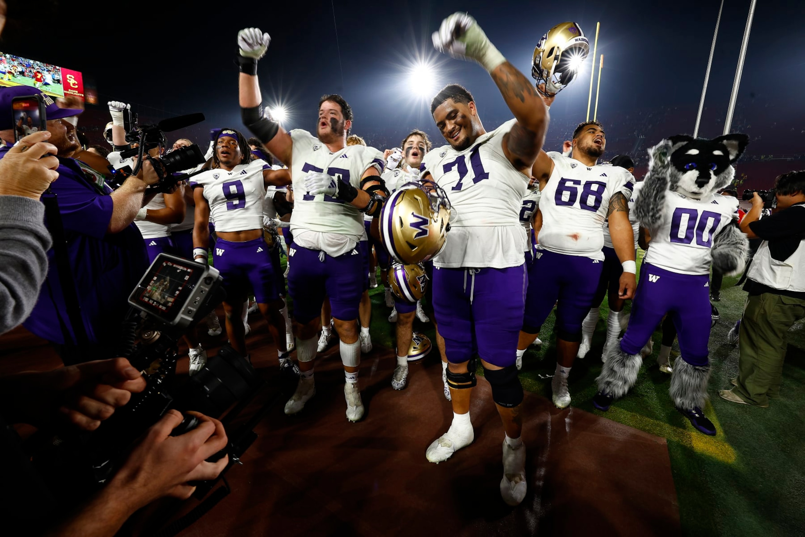 LOS ANGELES, CALIFORNIA - NOVEMBER 04:  The Washington Huskies celebrates a win against the USC Trojans at United Airlines Field at the Los Angeles Memorial Coliseum on November 04, 2023 in Los Angeles, California. (Photo by Ronald Martinez/Getty Images)
