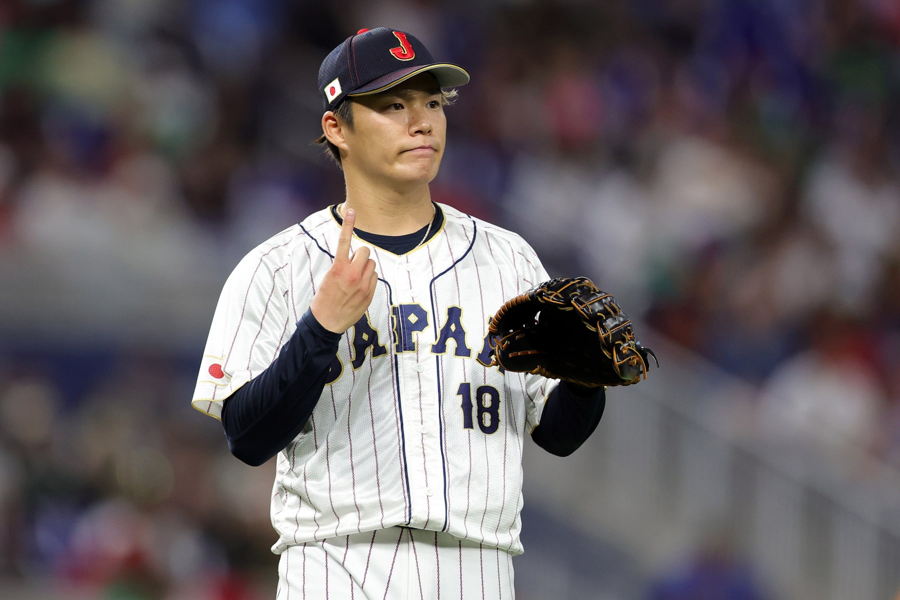MIAMI, FLORIDA - MARCH 20: Yoshinobu Yamamoto #18 of Team Japan reacts in the fifth inning against Team Mexico during the World Baseball Classic Semifinals at loanDepot park on March 20, 2023 in Miami, Florida. (Photo by Megan Briggs/Getty Images)