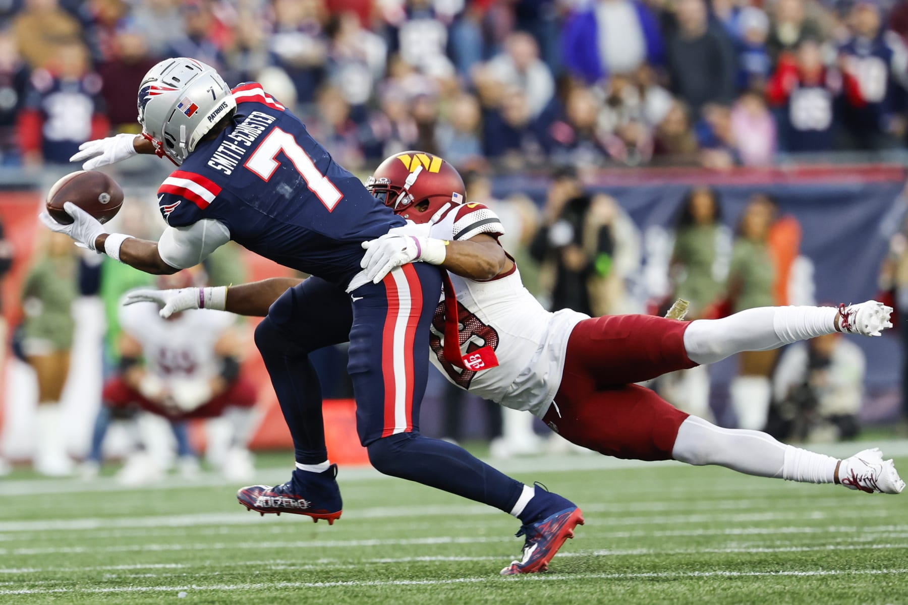 New England Patriots wide receiver JuJu Smith-Schuster (7) attempts to make a reception while defended by Washington Commanders cornerback Kendall Fuller (29) during the second half an NFL football game on Sunday, Nov. 5, 2023, in Foxborough, Mass. (AP Photo/Greg M. Cooper)