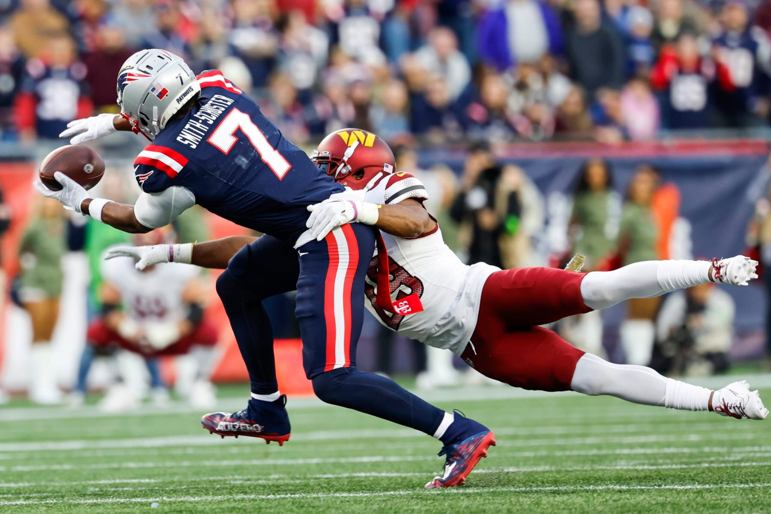 New England Patriots wide receiver JuJu Smith-Schuster (7) attempts to make a reception while defended by Washington Commanders cornerback Kendall Fuller (29) during the second half an NFL football game on Sunday, Nov. 5, 2023, in Foxborough, Mass. (AP Photo/Greg M. Cooper)