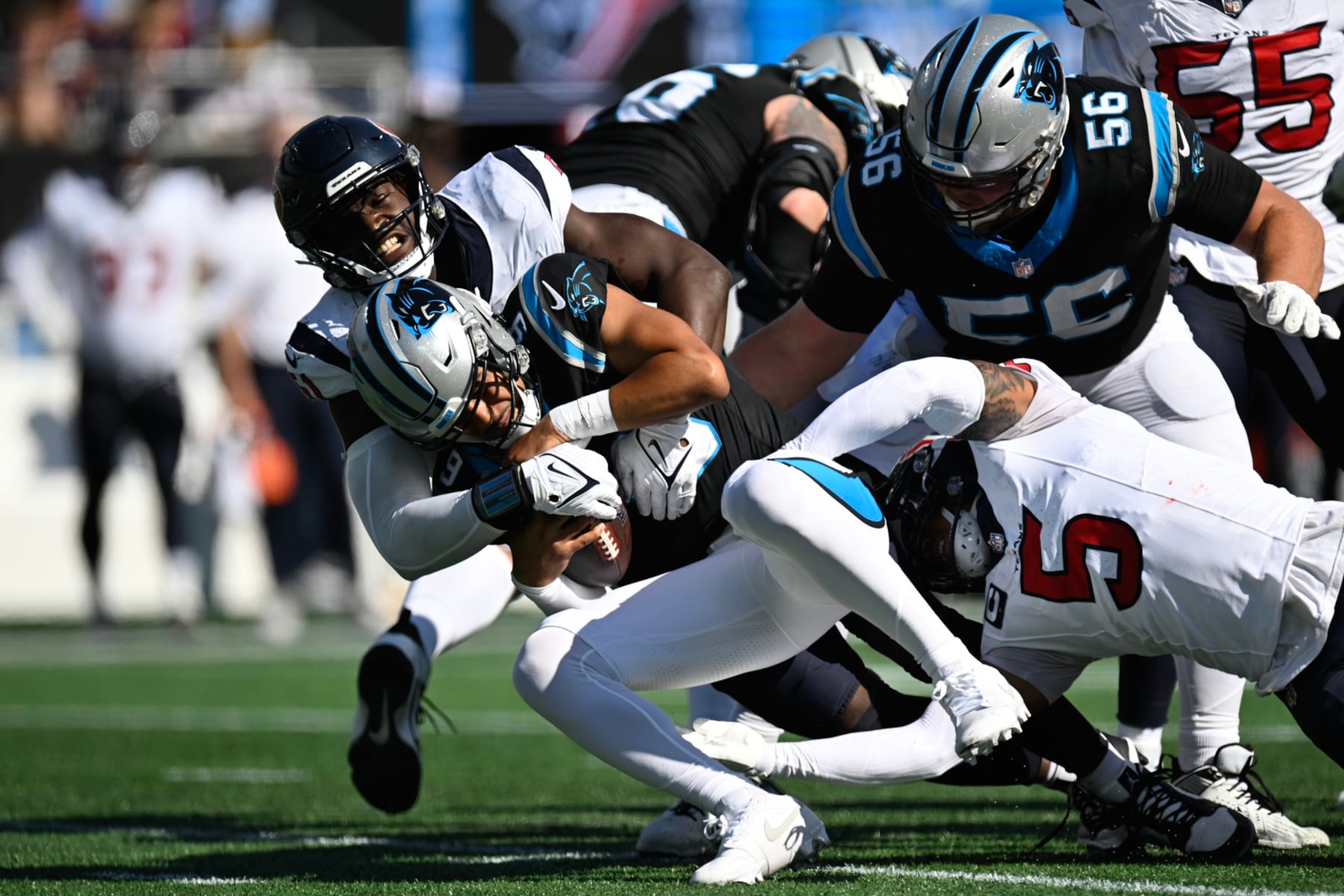 CHARLOTTE, NORTH CAROLINA - OCTOBER 29: Bryce Young #9 of the Carolina Panthers is sacked by Will Anderson Jr. #51 and Jalen Pitre #5 of the Houston Texans during the second quarter of the game at Bank of America Stadium on October 29, 2023 in Charlotte, North Carolina. (Photo by Eakin Howard/Getty Images)