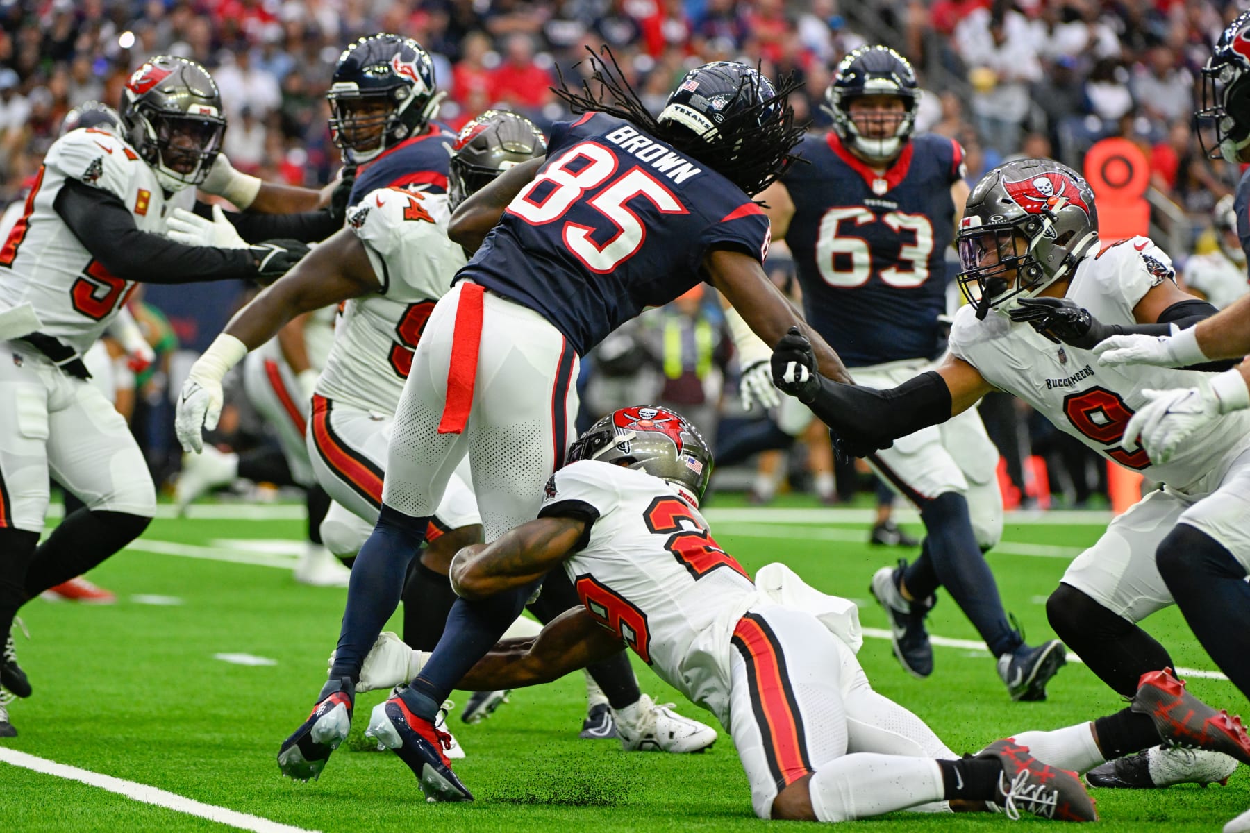 HOUSTON, TX - NOVEMBER 05: Houston Texans wide receiver Noah Brown (85) is tackled by Tampa Bay Buccaneers safety Christian Izien (29) during the football game between the Tampa Bay Buccaneers and Houston Texans at NRG Stadium on November 5, 2023, in Houston, Texas. (Photo by Ken Murray/Icon Sportswire via Getty Images)
