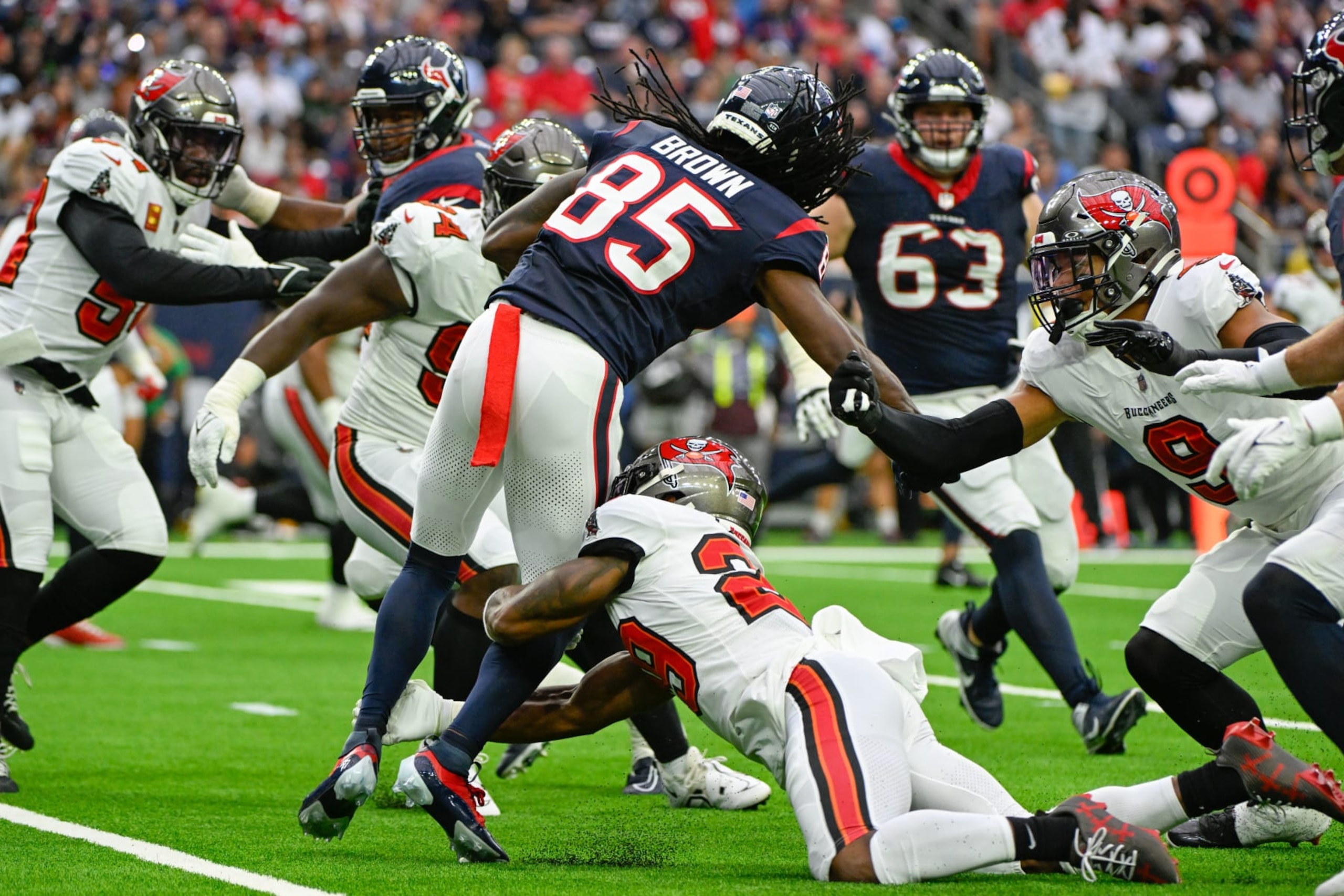 HOUSTON, TX - NOVEMBER 05: Houston Texans wide receiver Noah Brown (85) is tackled by Tampa Bay Buccaneers safety Christian Izien (29) during the football game between the Tampa Bay Buccaneers and Houston Texans at NRG Stadium on November 5, 2023, in Houston, Texas. (Photo by Ken Murray/Icon Sportswire via Getty Images)