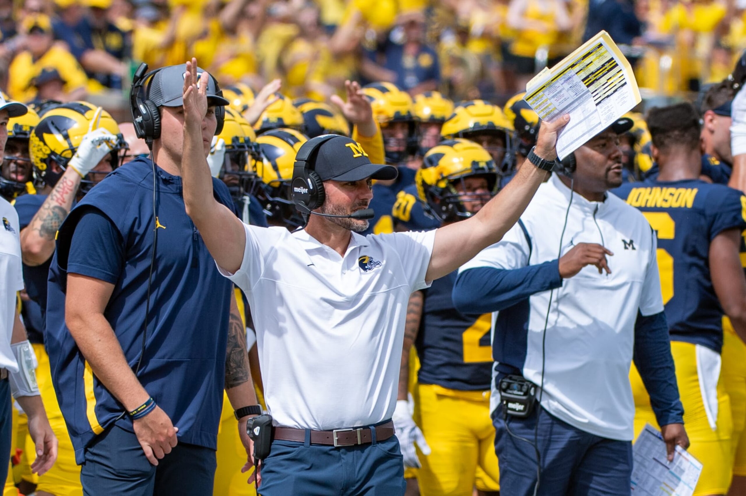 ANN ARBOR, MICHIGAN - SEPTEMBER 02: Acting Head Coach Jesse Minter of the Michigan Wolverines signals a touchdown during the second half of a college football game against the East Carolina Pirates at Michigan Stadium on September 02, 2023 in Ann Arbor, Michigan. The Michigan Wolverines won the game 30-3. (Photo by Aaron J. Thornton/Getty Images)