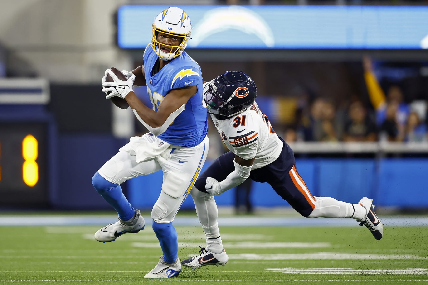 INGLEWOOD, CALIFORNIA - OCTOBER 29: Donald Parham Jr. #89 of the Los Angeles Chargers runs with the ball while being chased by Jaylon Jones #31 of the Chicago Bears in the third quarter at SoFi Stadium on October 29, 2023 in Inglewood, California. (Photo by Ronald Martinez/Getty Images)