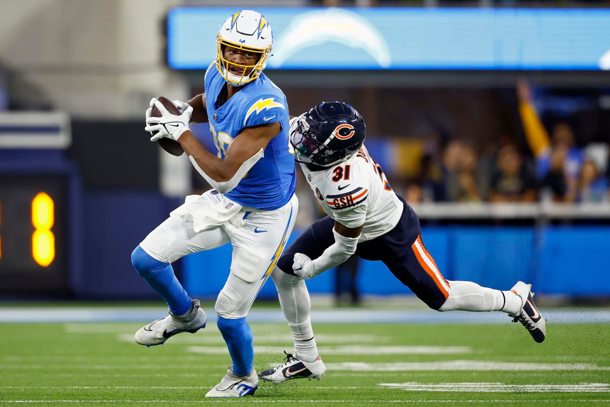 INGLEWOOD, CALIFORNIA - OCTOBER 29: Donald Parham Jr. #89 of the Los Angeles Chargers runs with the ball while being chased by Jaylon Jones #31 of the Chicago Bears in the third quarter at SoFi Stadium on October 29, 2023 in Inglewood, California. (Photo by Ronald Martinez/Getty Images)
