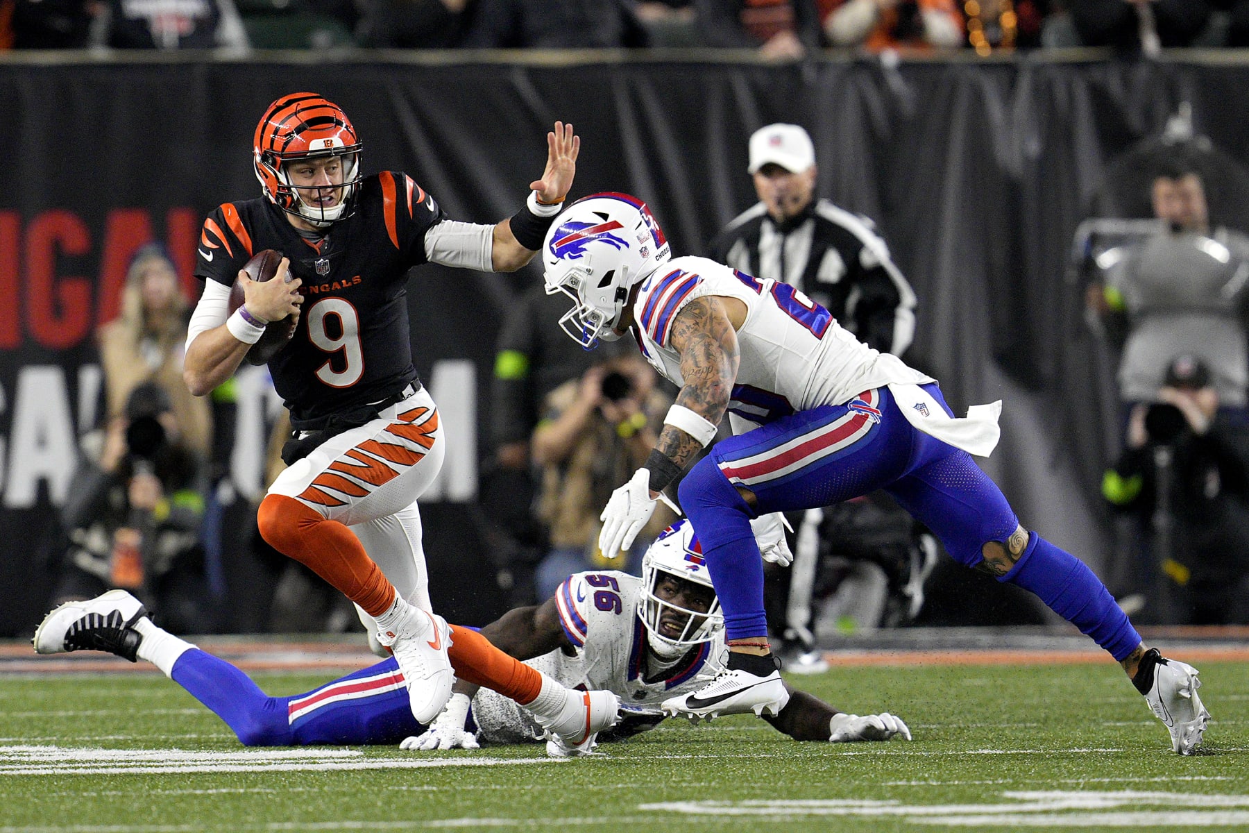 CINCINNATI, OHIO - NOVEMBER 05:  Joe Burrow #9 of the Cincinnati Bengals carries the ball against Taylor Rapp #20 of the Buffalo Bills during the third quarter at Paycor Stadium on November 05, 2023 in Cincinnati, Ohio. (Photo by Jeff Dean/Getty Images)