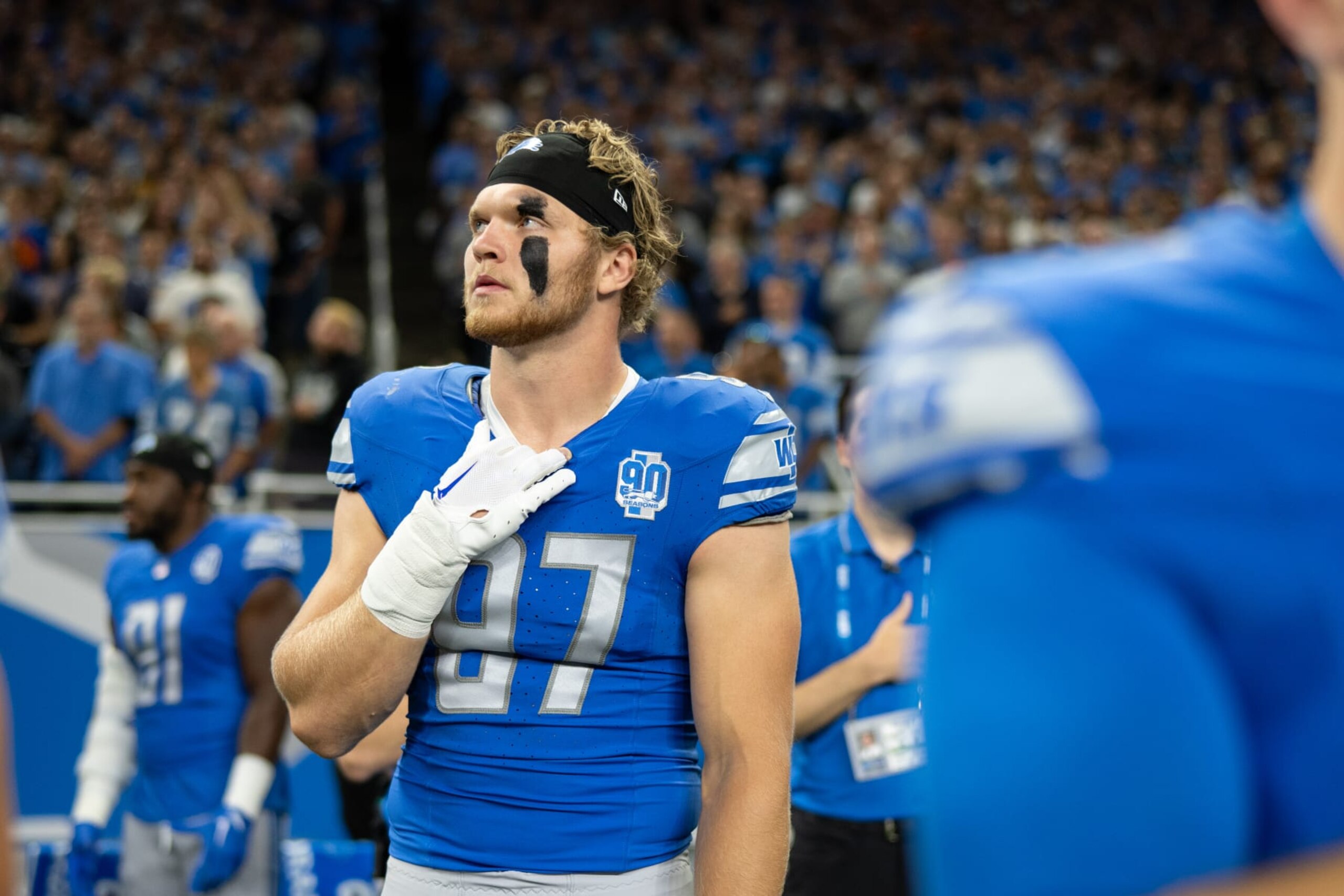 DETROIT, MI - SEPTEMBER 17: Defensive end Aiden Hutchinson #97 of the Detroit Lions looks on during the National Anthem prior to an NFL football game against the Seattle Seahawks at Ford Field on September 17, 2023 in Detroit, Michigan. (Photo by Todd Rosenberg/Getty Images) DETROIT, MI - SEPTEMBER 17: Defensive end Aiden Hutchinson #97 of the Detroit Lions looks on during the National Anthem prior to an NFL football game against the Seattle Seahawks at Ford Field on September 17, 2023 in Detroit, Michigan. (Photo by Todd Rosenberg/Getty Images)