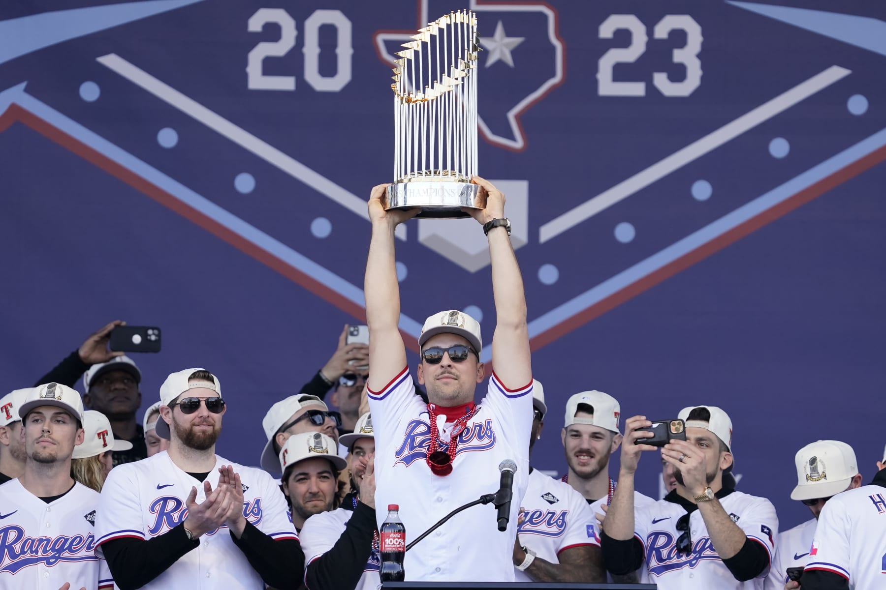 ARLINGTON, TEXAS - NOVEMBER 03: Nathaniel Lowe #30 of the Texas Rangers lifts the Commissioner's Trophy during the World Series Championship celebration at Globe Life Field on November 03, 2023 in Arlington, Texas. (Photo by Sam Hodde/Getty Images)