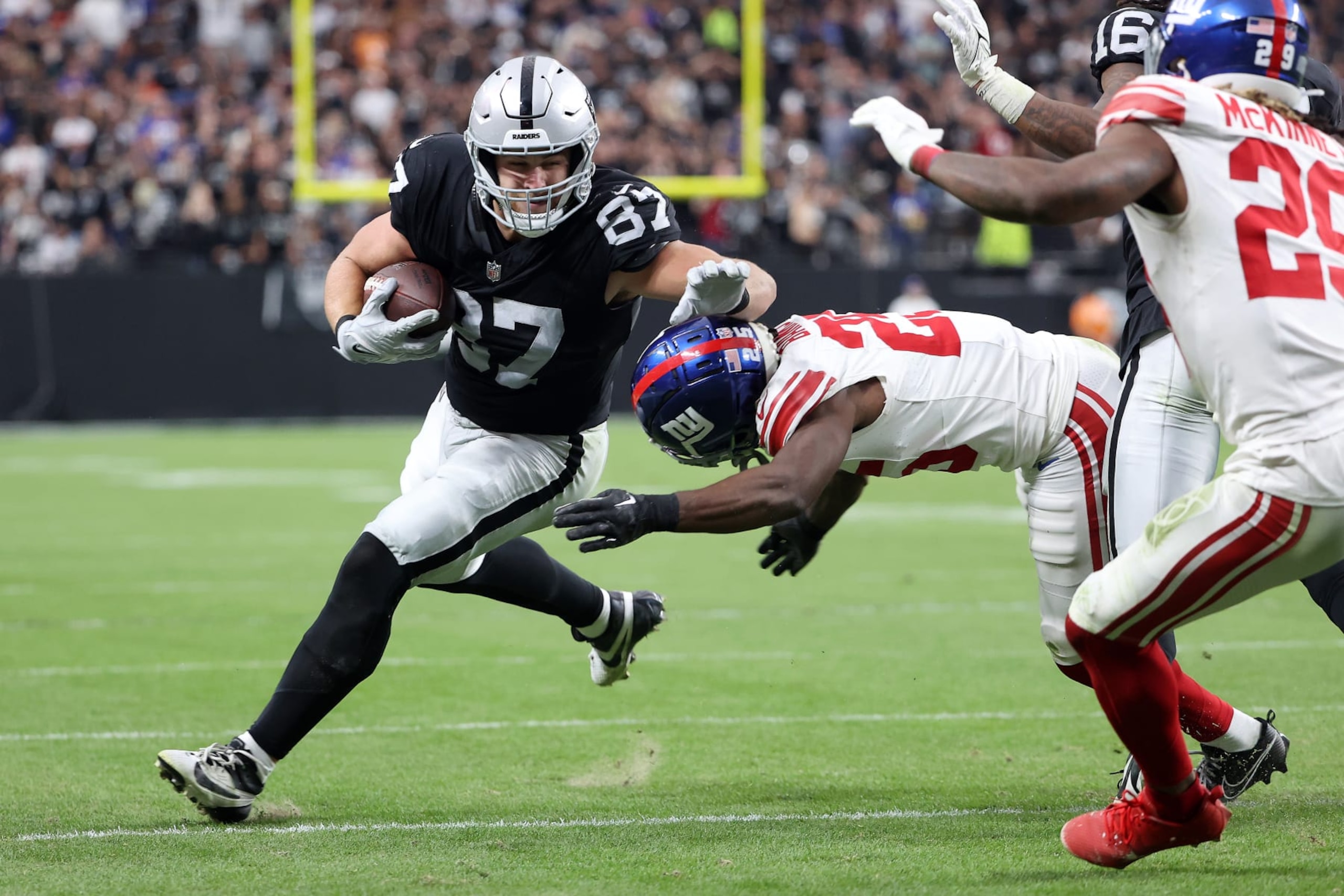 LAS VEGAS, NEVADA - NOVEMBER 05: Michael Mayer #87 of the Las Vegas Raiders breaks a tackle by Deonte Banks #25 of the New York Giants in the second quarter of a game at Allegiant Stadium on November 05, 2023 in Las Vegas, Nevada. (Photo by Ian Maule/Getty Images)