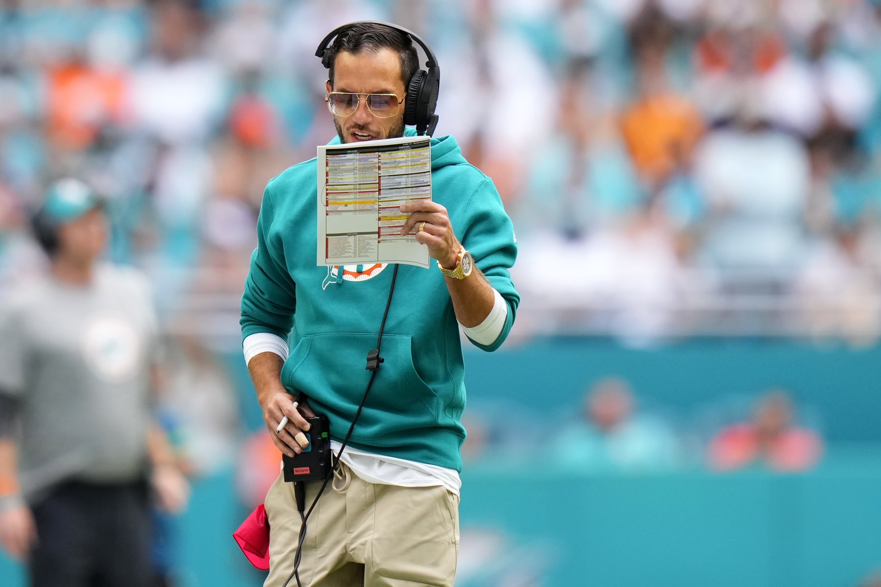 MIAMI GARDENS, FLORIDA - OCTOBER 29: Head coach Mike McDaniel of the Miami Dolphins looks at his play sheet during the second quarter against the New England Patriots at Hard Rock Stadium on October 29, 2023 in Miami Gardens, Florida. (Photo by Rich Storry/Getty Images)