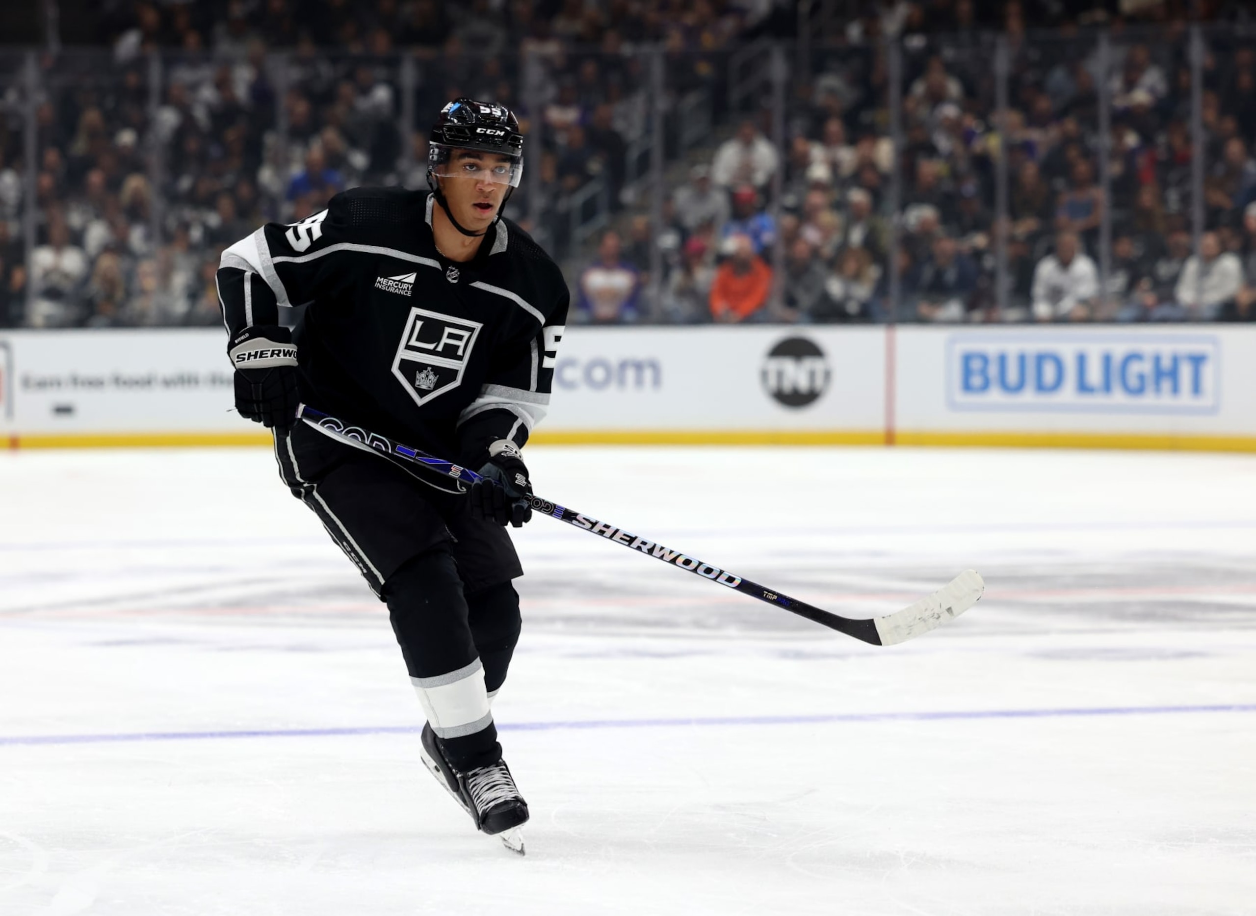 LOS ANGELES, CALIFORNIA - OCTOBER 11: Quinton Byfield #55 of the Los Angeles Kings watches his passduring a 5-3 loss to the Colorado Avalanche in the Los Angeles Kings season opening game at Crypto.com Arena on October 11, 2023 in Los Angeles, California. (Photo by Harry How/Getty Images)