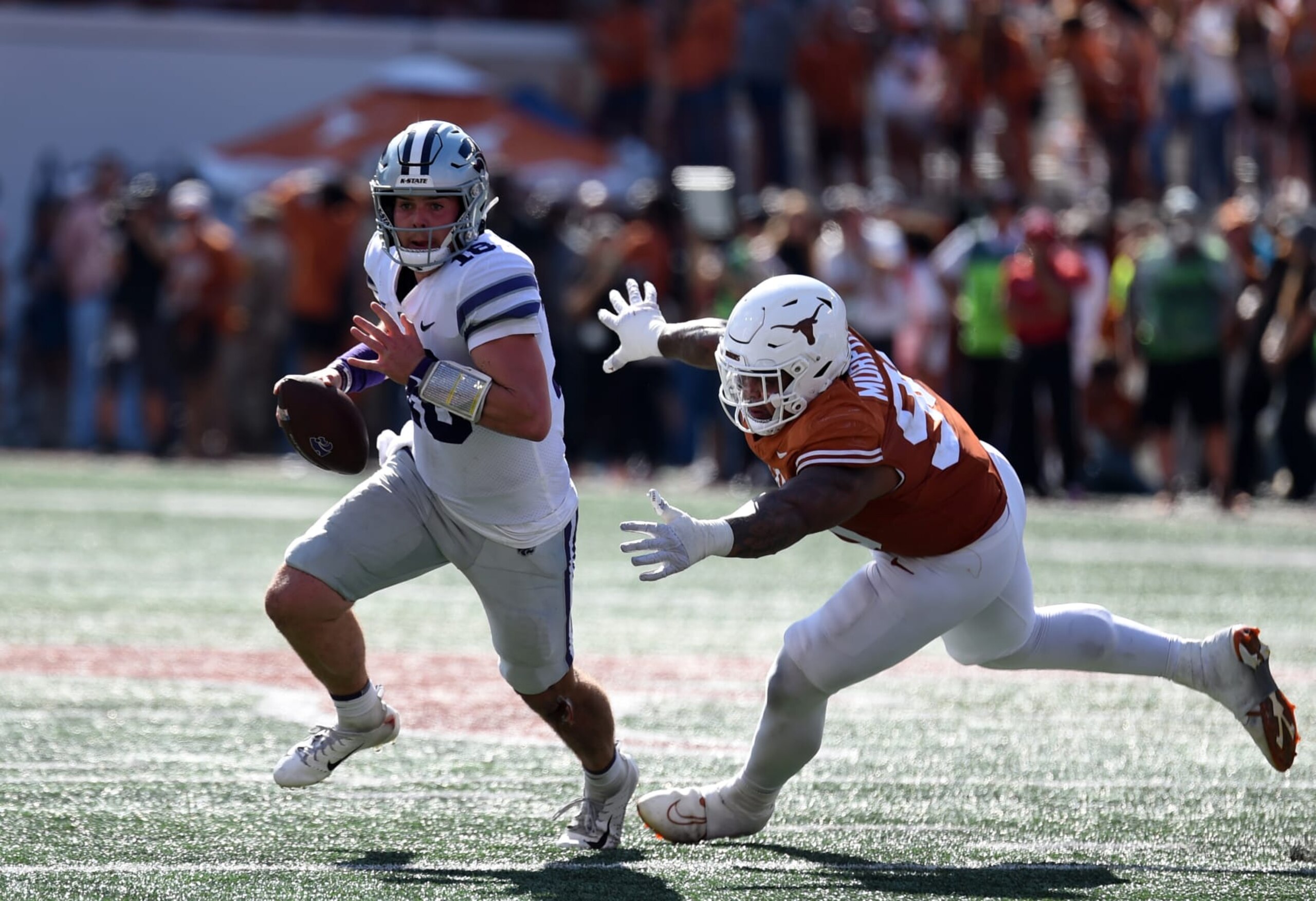 AUSTIN, TX - NOVEMBER 04: Kansas State Wildcats QB Will Howard (18) runs from Texas Longhorns DT Byron Murphy (90) during the college football game between the Kansas State Wildcats and the Texas Longhorns on November 4, 2023, at Darrell K Royal-Texas Memorial Stadium in Austin, TX. (Photo by John Rivera/Icon Sportswire via Getty Images)