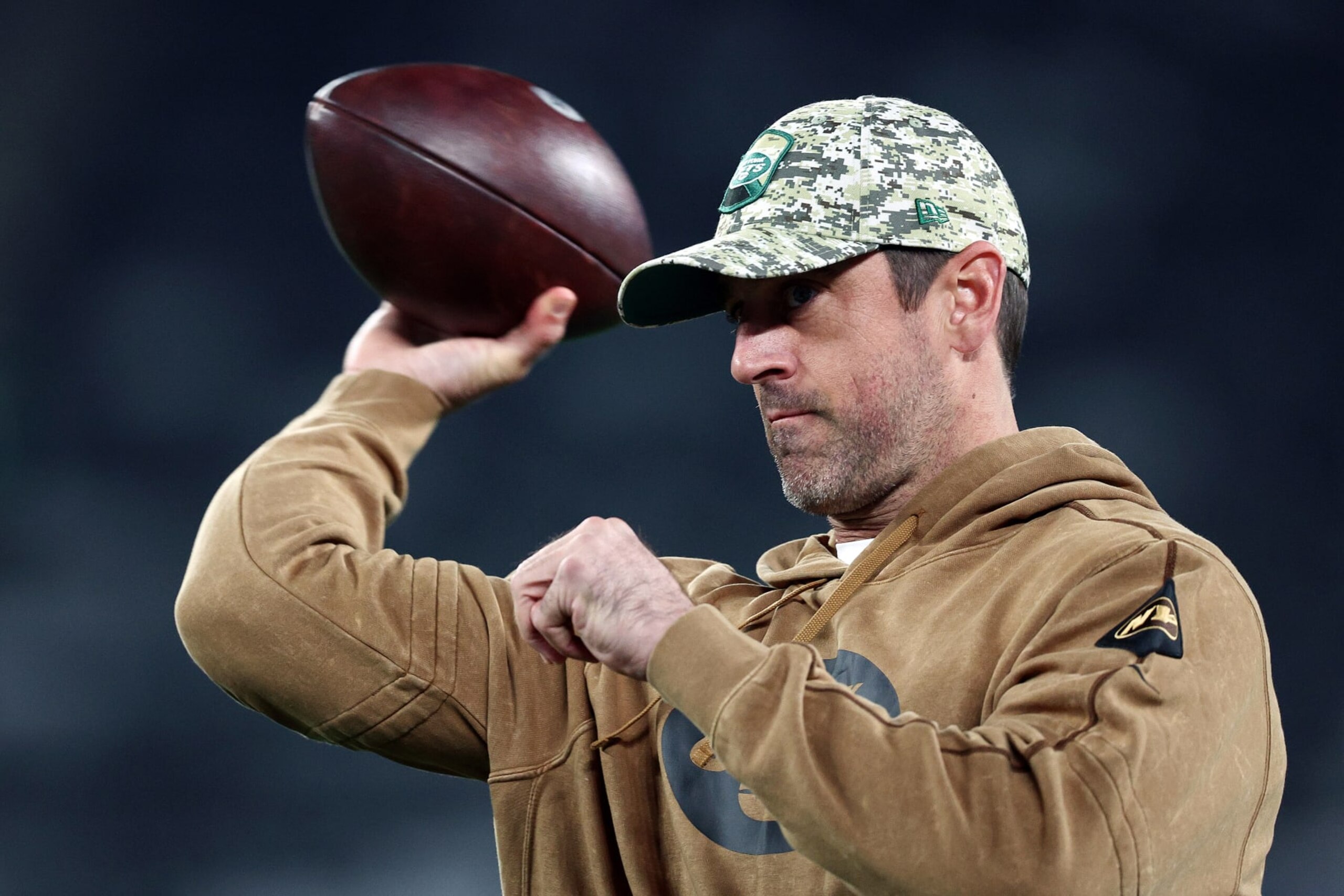 EAST RUTHERFORD, NEW JERSEY - NOVEMBER 06:  Aaron Rodgers #8 of the New York Jets throws a football before the game against the Los Angeles Chargers at MetLife Stadium on November 06, 2023 in East Rutherford, New Jersey. (Photo by Elsa/Getty Images)