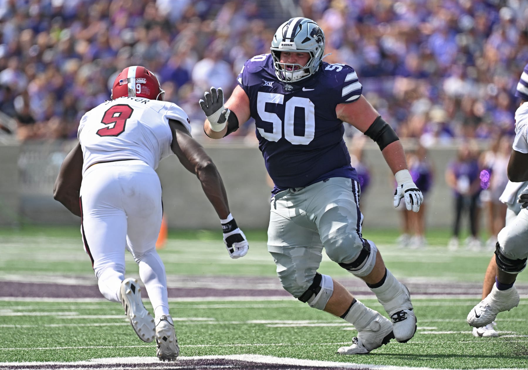 MANHATTAN, KS - SEPTEMBER 09:  Offensive lineman Cooper Beebe #50 of the Kansas State Wildcats gets set to block linebacker Richard Jibunor #9 of the Troy Trojans in the first half at Bill Snyder Family Football Stadium on September 09, 2023 in Manhattan, Kansas. (Photo by Peter G. Aiken/Getty Images)