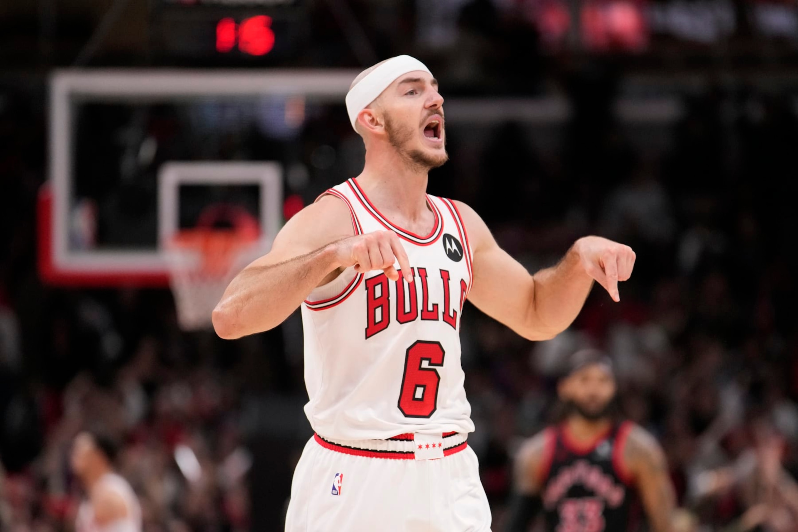 Chicago Bulls' Alex Caruso celebrates his three-point basket with just seconds remaining during an NBA basketball game against the Toronto Raptors Friday, Oct. 27, 2023, in Chicago. (AP Photo/Charles Rex Arbogast)