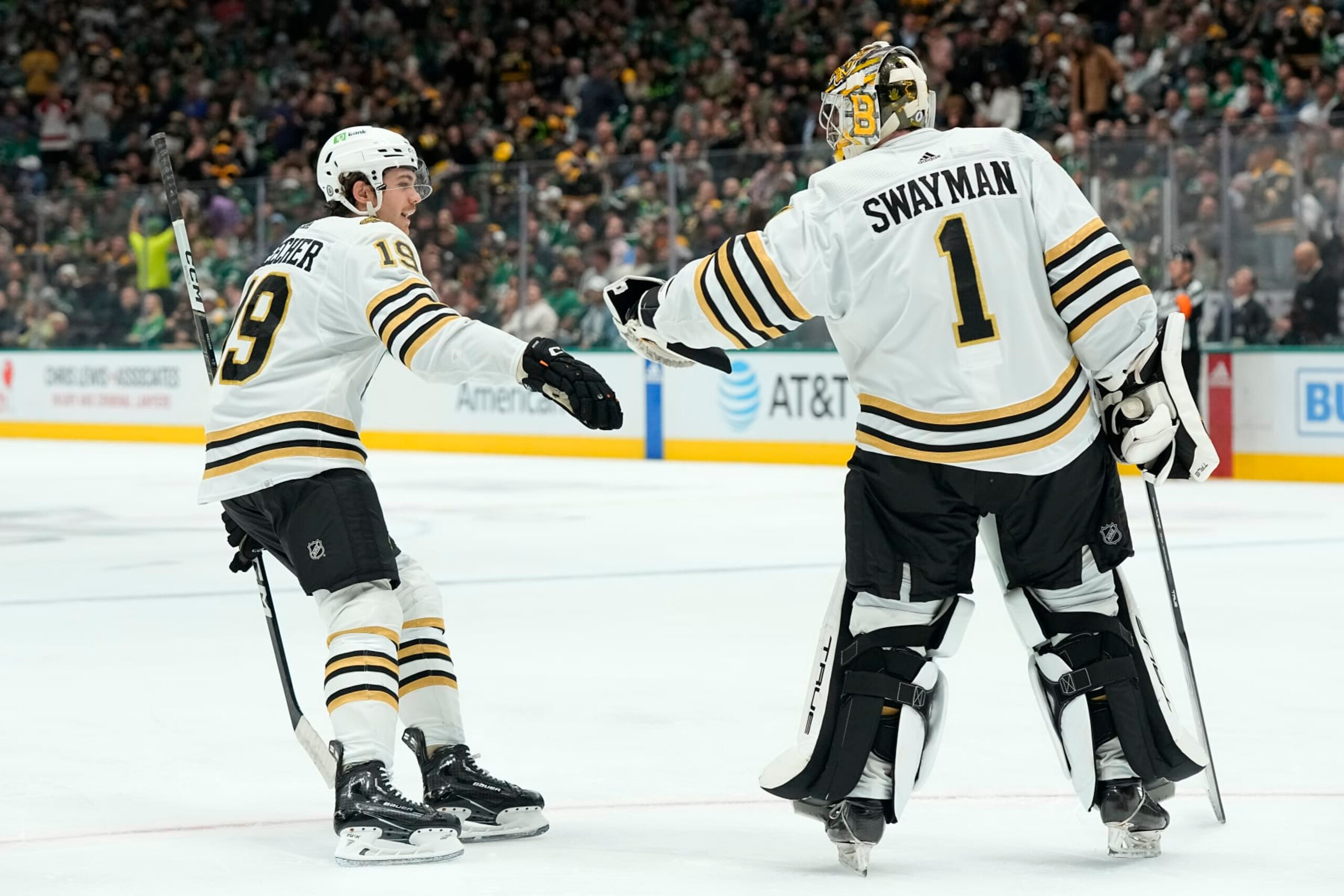 DALLAS, TEXAS - NOVEMBER 06: Johnny Beecher #19 of the Boston Bruins is congratulated by Jeremy Swayman #1 after scoring his first career NHL goal during the first period against the Dallas Stars at American Airlines Center on November 06, 2023 in Dallas, Texas. (Photo by Sam Hodde/Getty Images)