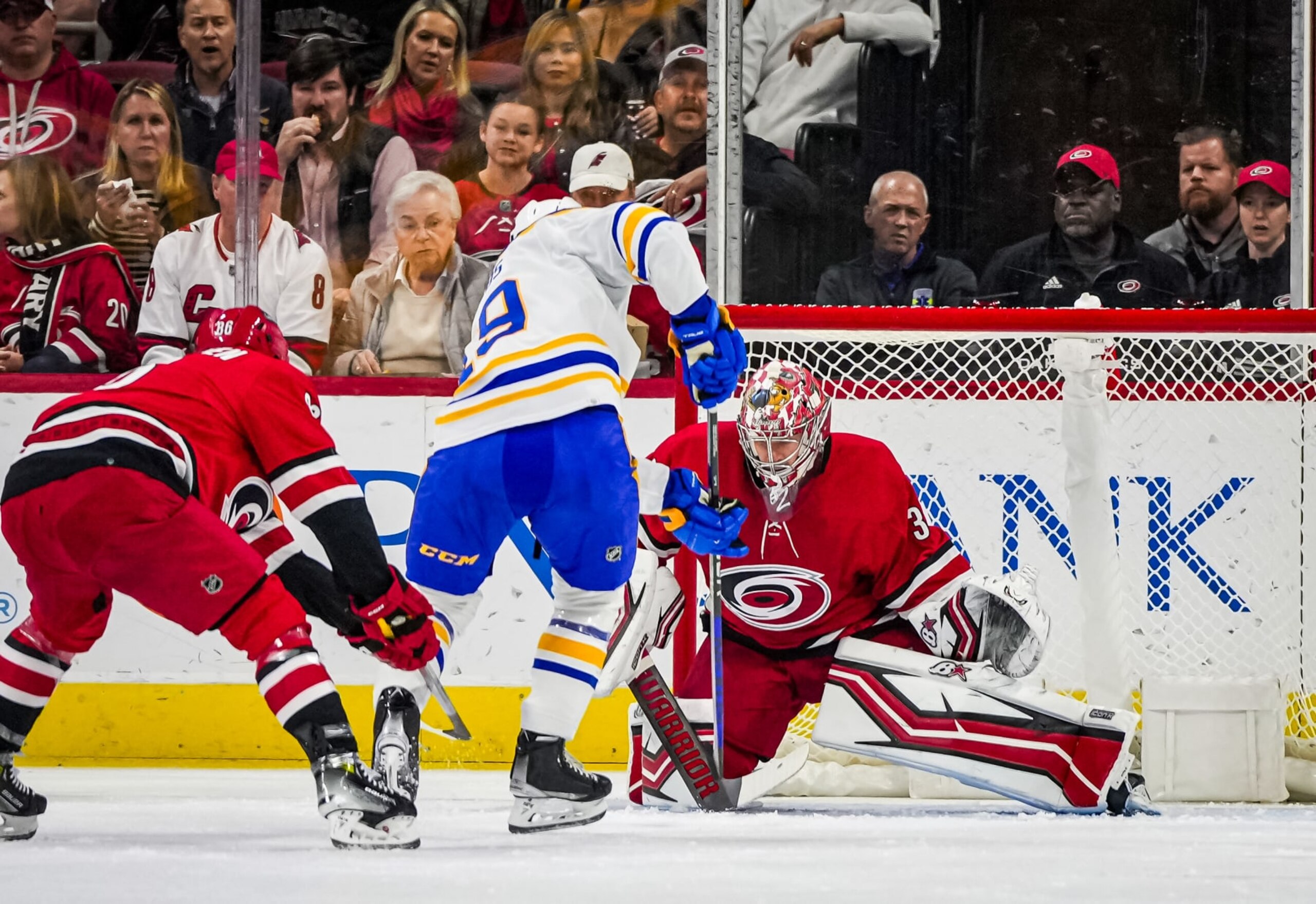 RALEIGH, NORTH CAROLINA - NOVEMBER 07: Antti Raanta #32 of the Carolina Hurricanes makes a save against Peyton Krebs #19 of the Buffalo Sabres during the first period at PNC Arena on November 07, 2023 in Raleigh, North Carolina. (Photo by Josh Lavallee/NHLI via Getty Images)
