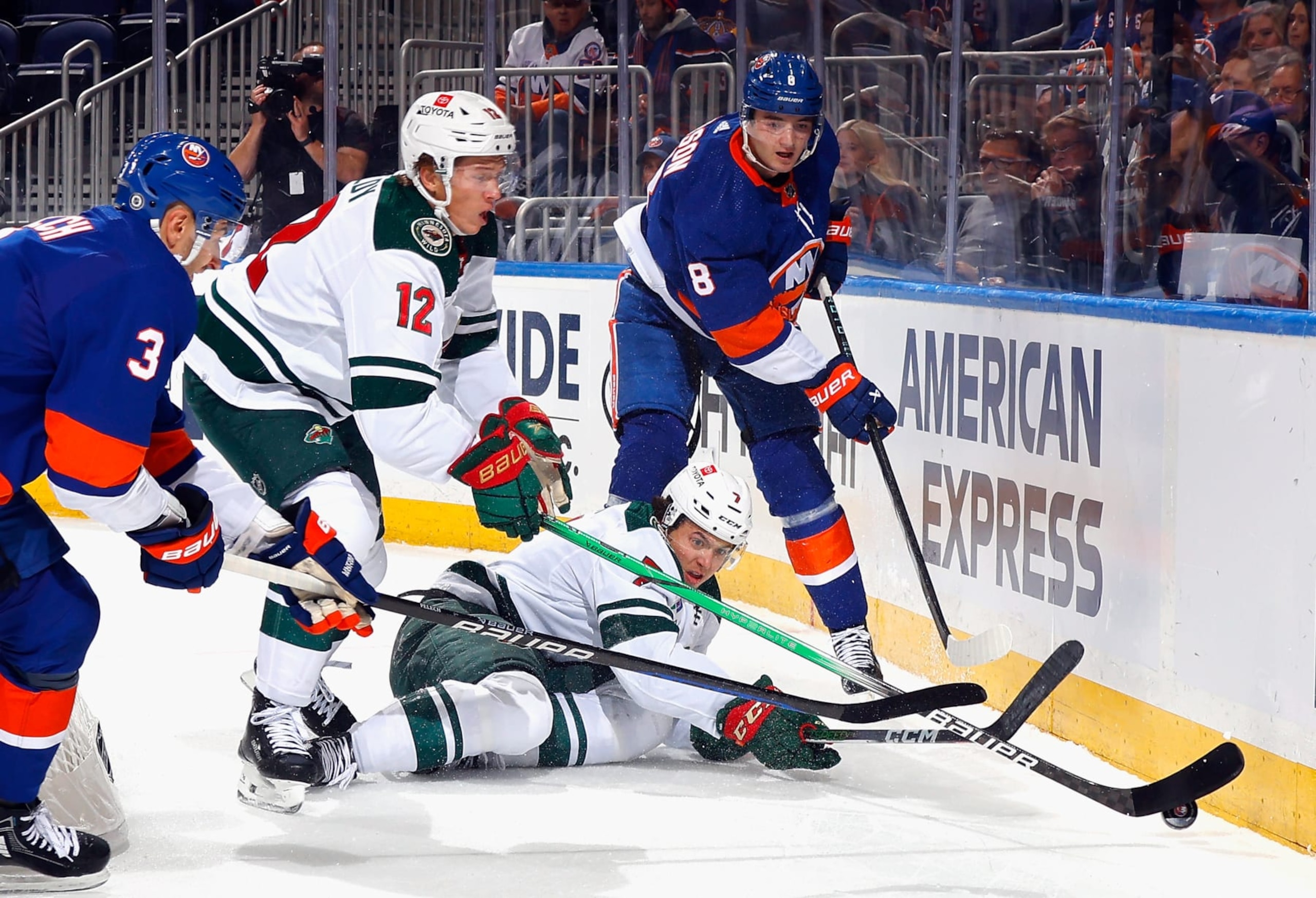 ELMONT, NEW YORK - NOVEMBER 07: Noah Dobson #8 of the New York Islanders defends against Matt Boldy #12 and Brock Faber #7 of the Minnesota Wild during the first period at UBS Arena on November 07, 2023 in Elmont, New York. (Photo by Bruce Bennett/Getty Images)
