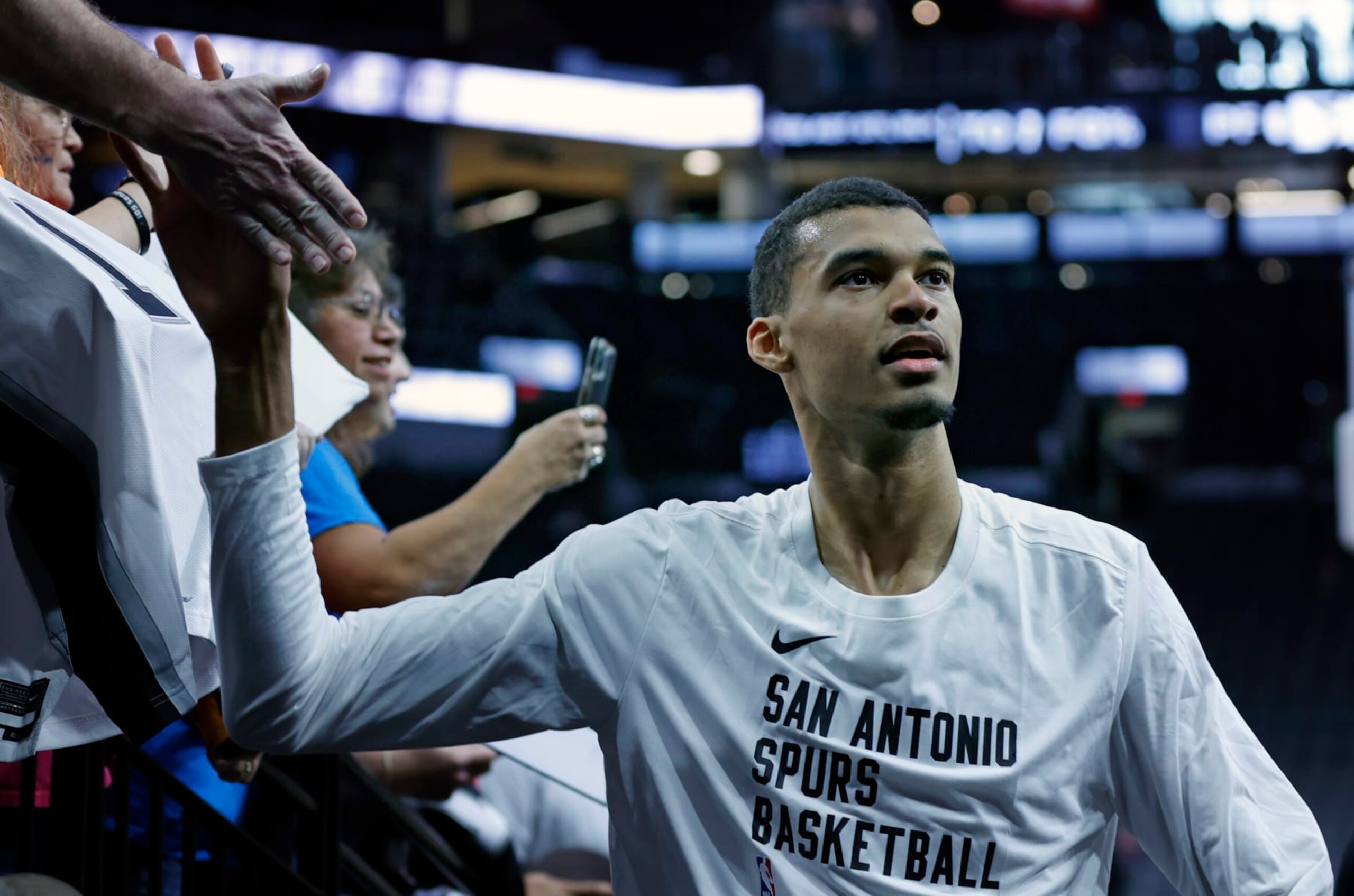 SAN ANTONIO, TX - NOVEMBER 5:  Victor Wembanyama #1 of the San Antonio Spurs greets fans before their game against the Toronto Raptors at Frost Bank Center on November  5, 2023 in San Antonio, Texas. NOTE TO USER: User expressly acknowledges and agrees that, by downloading and or using this photograph, User is consenting to terms and conditions of the Getty Images License Agreement. (Photo by Ronald Cortes/Getty Images)
